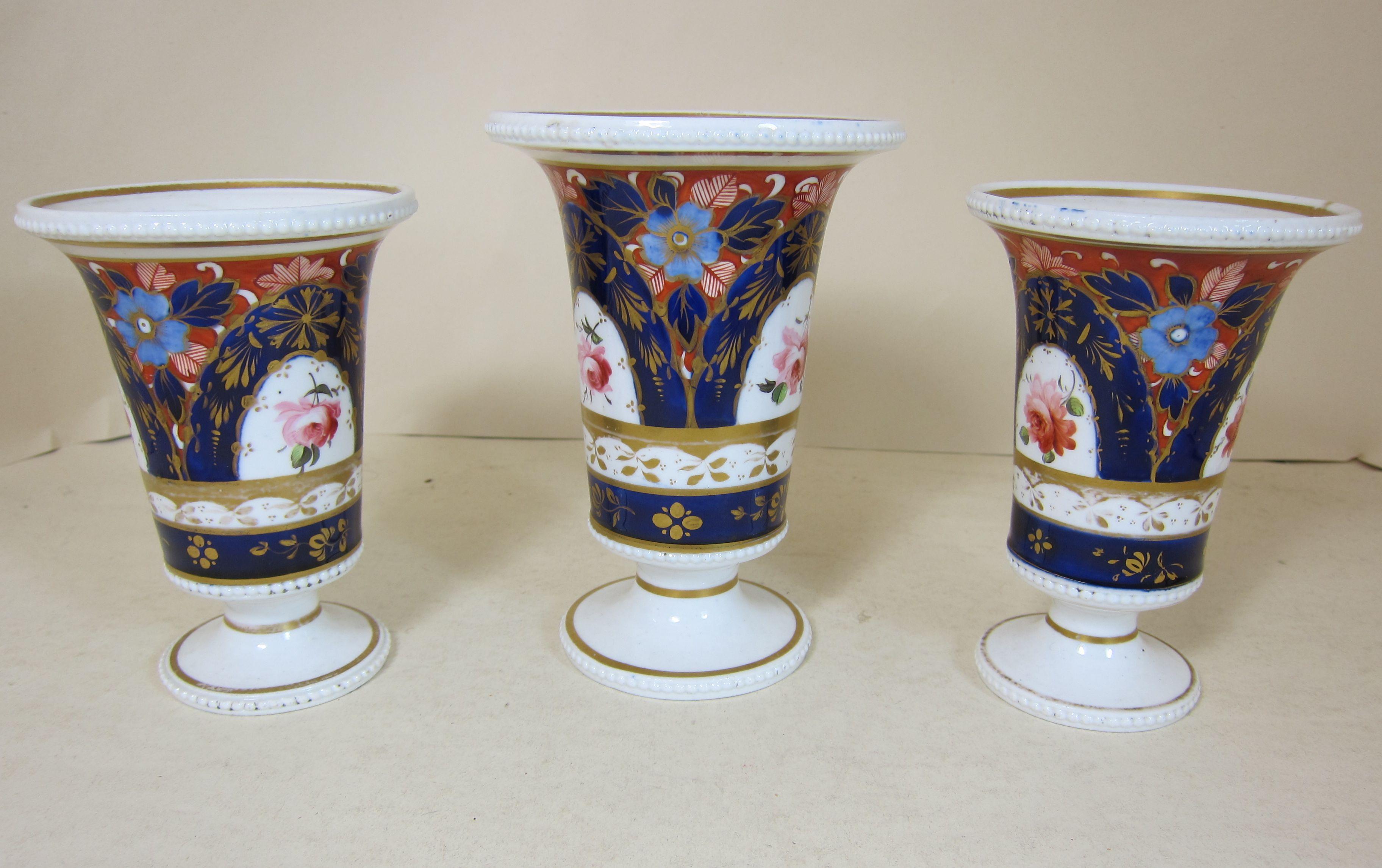 A Garniture of 3 Spode porcelain vases decorated with a blue ground gilding and roses tall vase 10.50