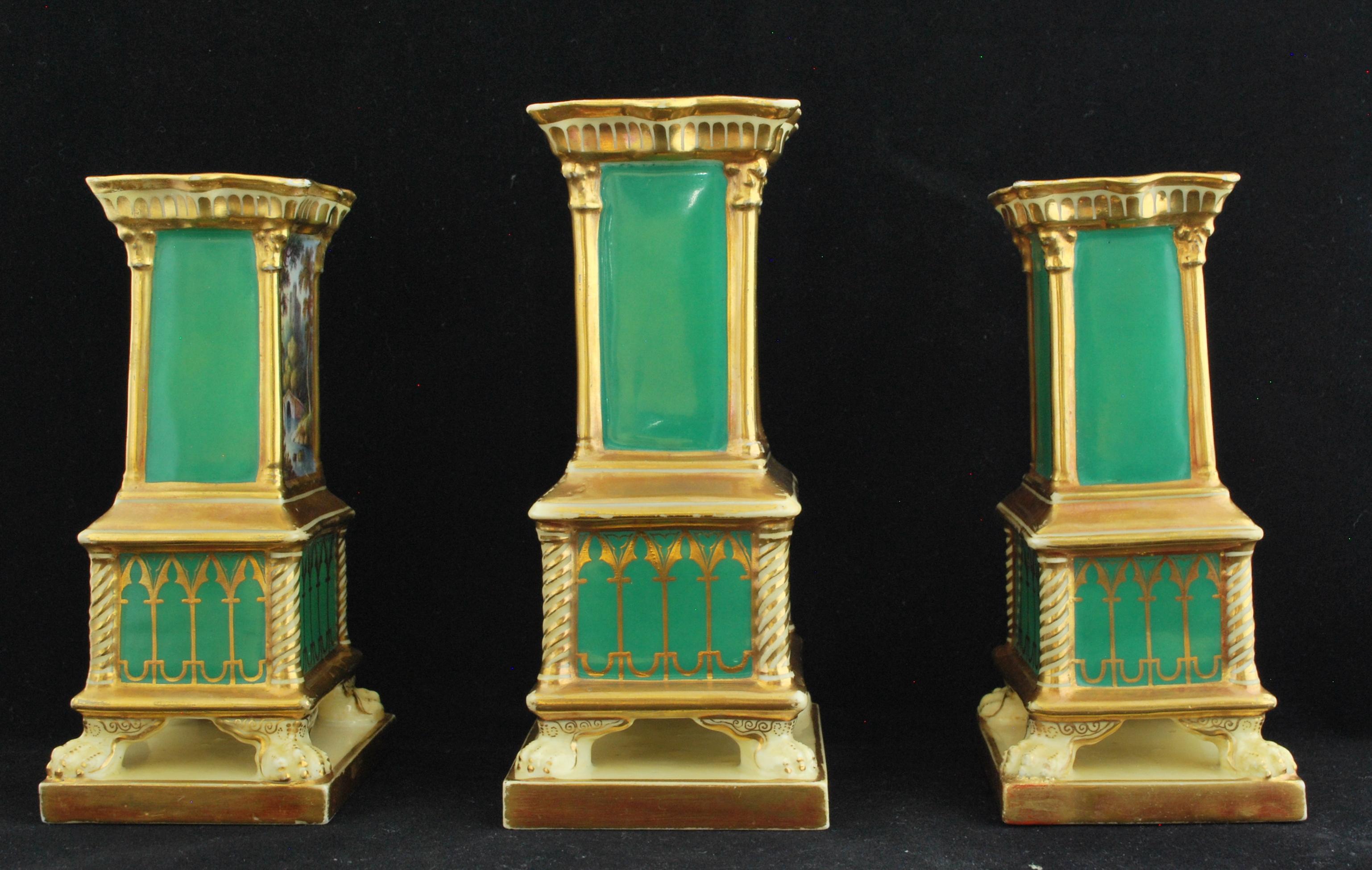 Set of three spill vases, or Match Pots, decorated in the Gothic Revival manner, with reserves showing finely detailed landscapes. The painting by Lark Pratt, who was working for Minton at the time.
