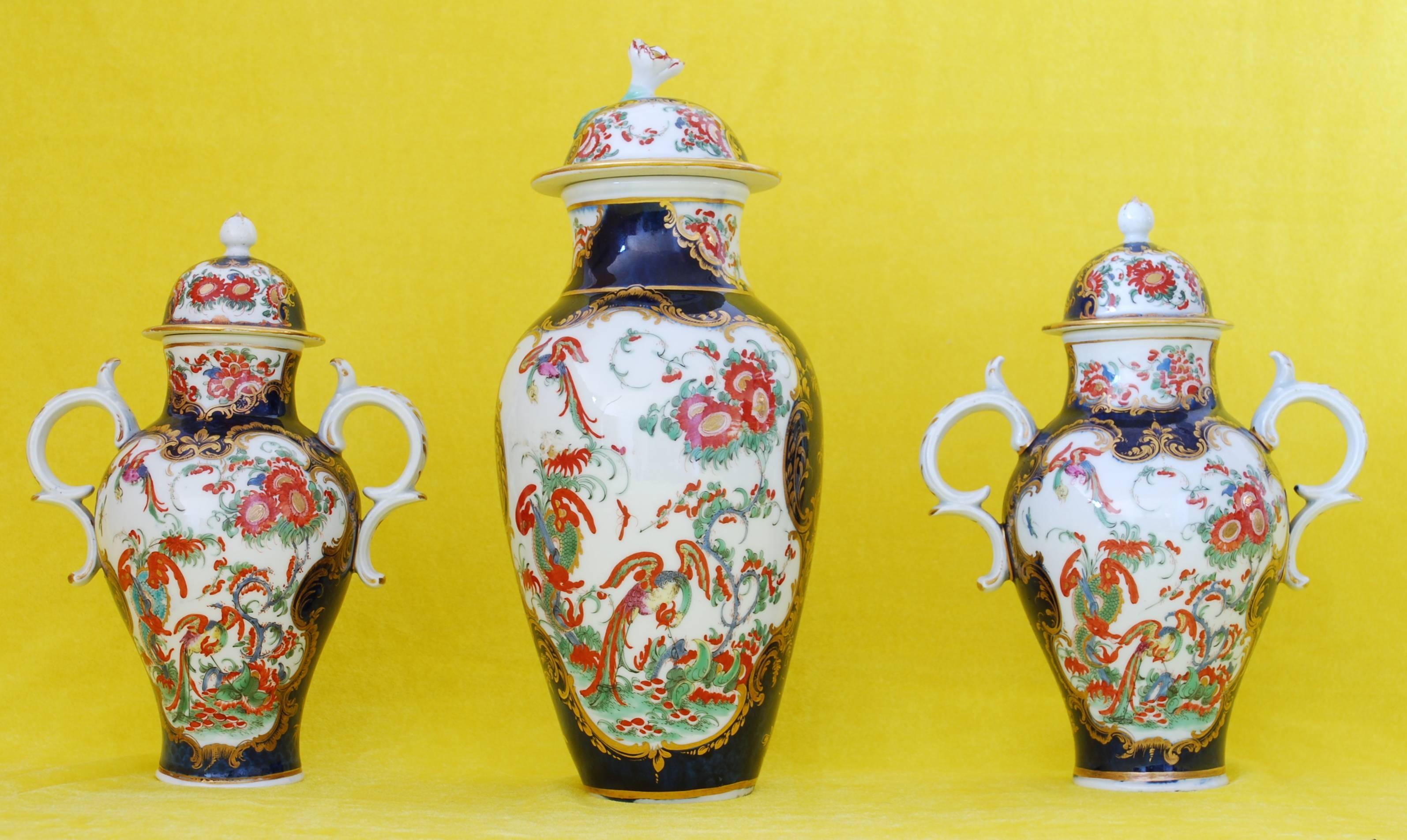 An assembled set of three vases in the scarce Jabberwocky pattern, on a scale blue background.