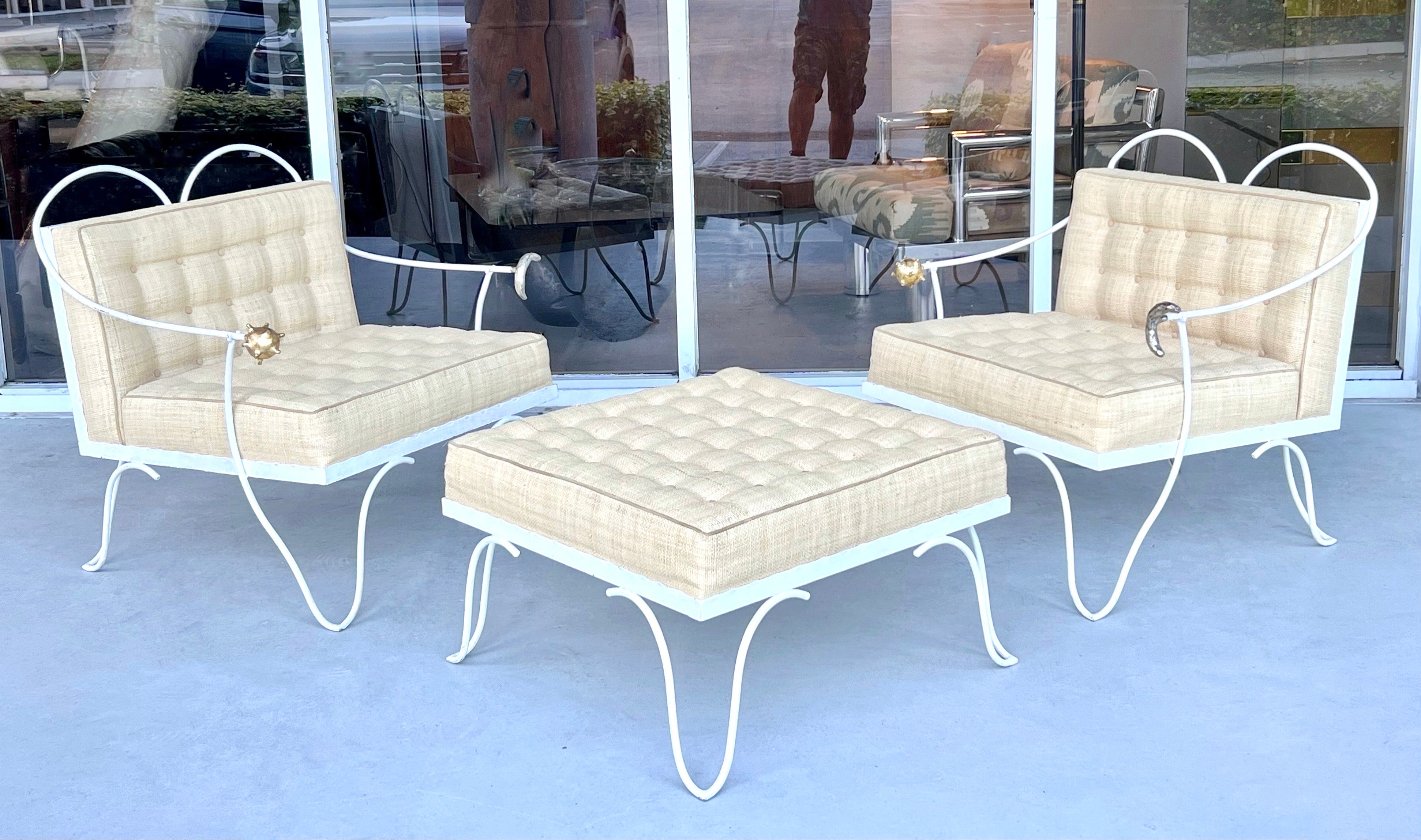 A pair of Garouste and Bonetti chairs and ottoman. Steel frames with hand applied white finish. A stylized representation of the sun and the moon at the end of the arms done in gold and silver leaf respectively. Retain the original hand woven raffia