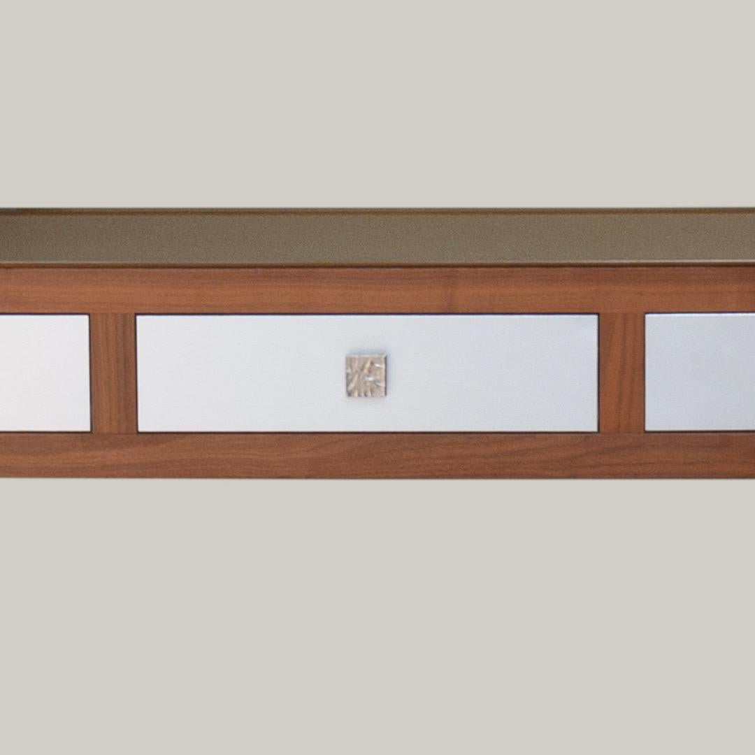 This Walnut console is part of the Walnut collection created by Garouste & Bonetti and edited by B.G.H.

Created around 2000 this model was conceived as an alliance of new materials and more conservative ones, the anodized aluminium and the walnut.