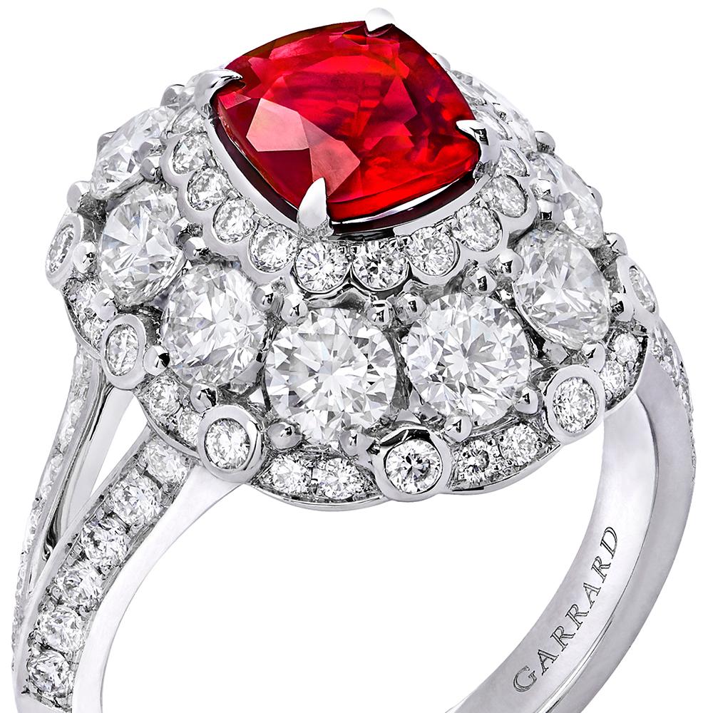 A House of Garrard 18 karat white gold ring from the Jewelled Vault collection, set with a central GRS certified cushion cut 1.36 carat ruby and 80 round white diamonds weighing 3.40 carats. 
1 cushion cut ruby weighing 1.36 carat GRS certified