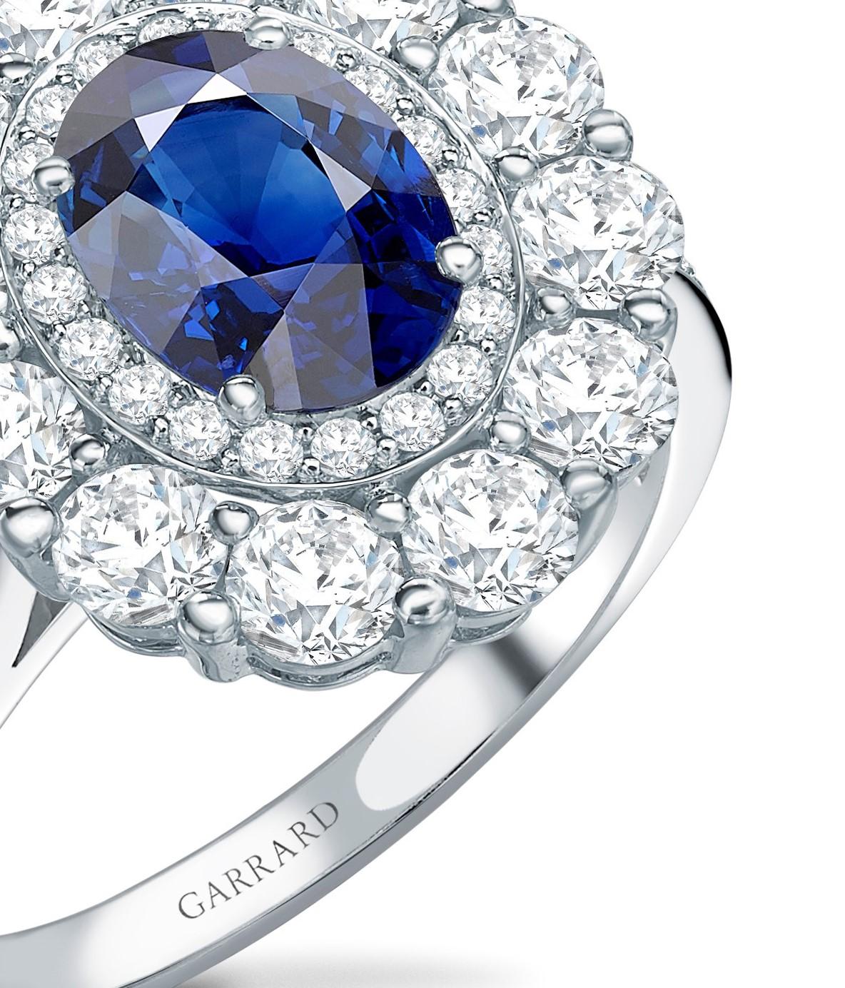 A House of Garrard platinum double cluster surround ring from the 1735 collection set with a central GIA certified oval blue sapphire weighing 1.37 carats and 58 round white diamonds weighing 1.56 carats
Size: 51 / L / 5 (3/4) (Ring can be sized up