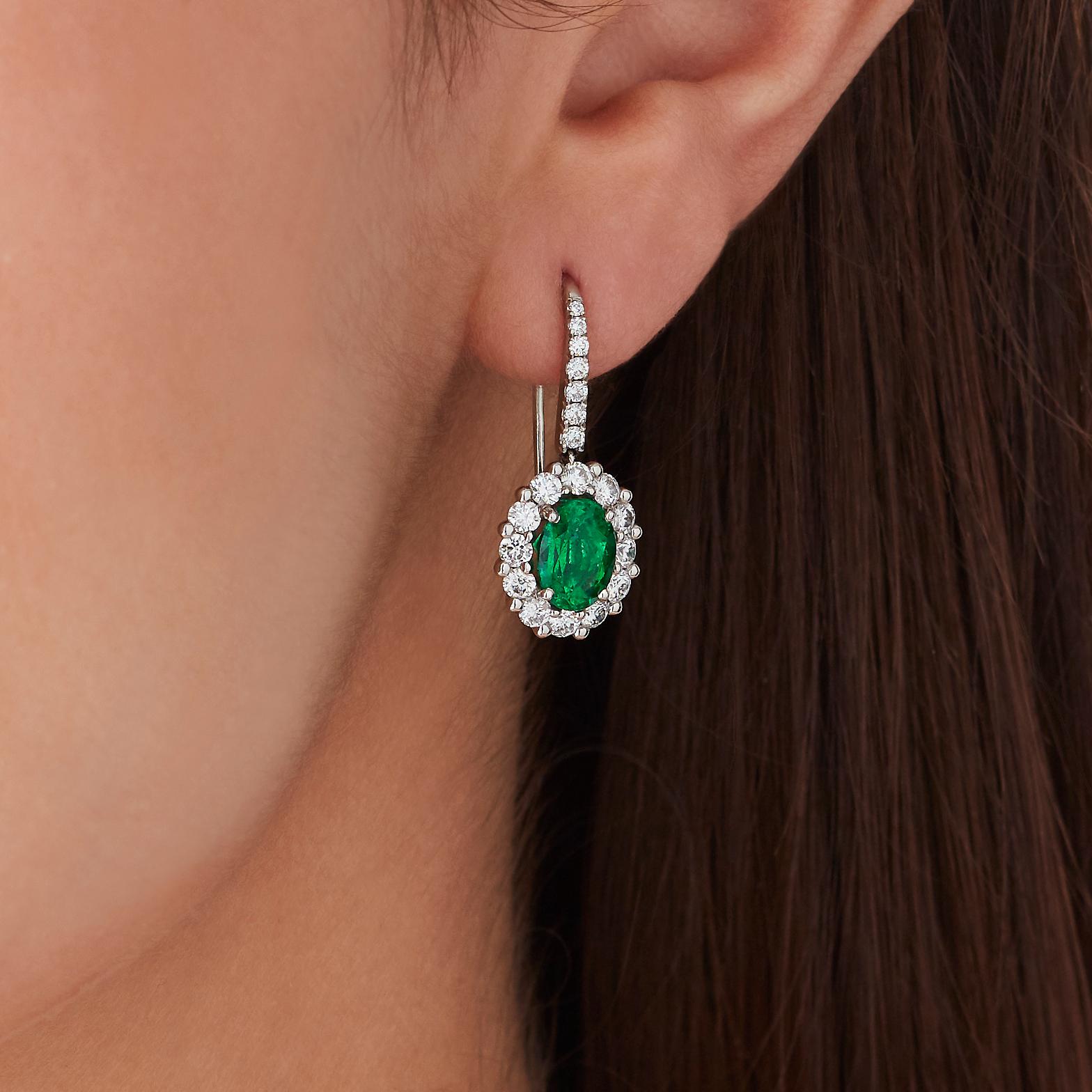 A House of Garrard pair of platinum drop earrings from the 'Garrard 1735' collection, set with central oval emeralds and round white diamonds.

2 oval emeralds 
GCS certified, Zambia
38 round white diamonds weighing: 1.18cts

Additional Photos and