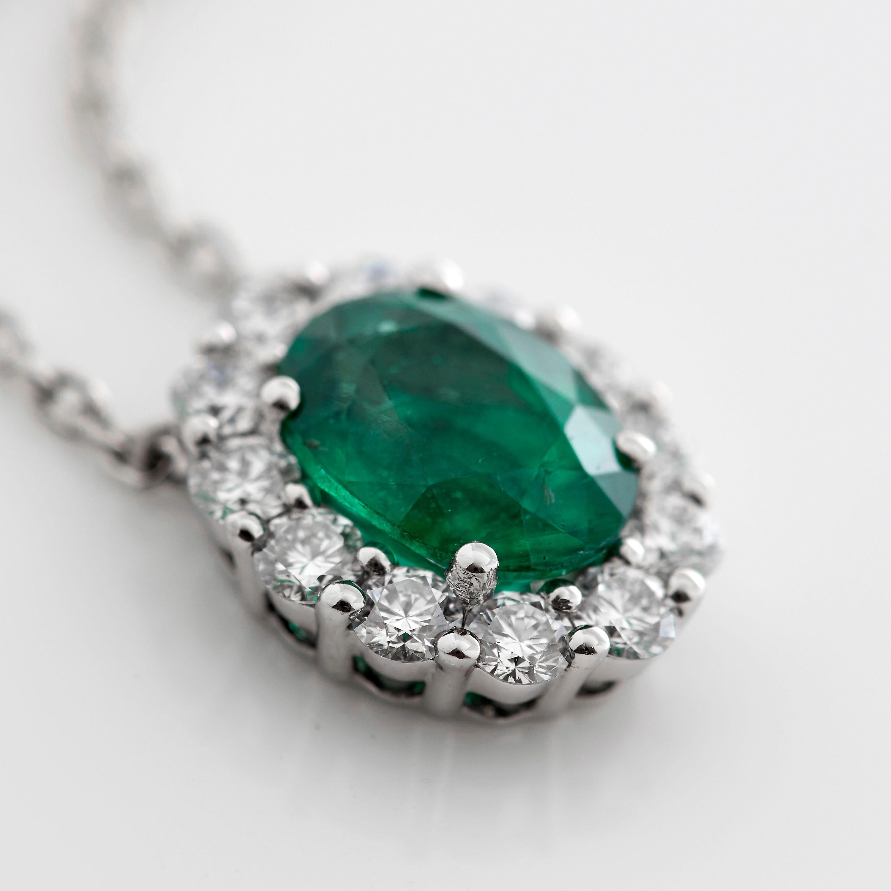 A House of Garrard platinum pendant from the 'Garrard 1735' collection, set with round white diamonds and a central oval emerald.

1 oval emerald weighing: 1.57cts
GIA certified, Mozambique, Heated
12 round white diamonds weighing: 0.52cts

The