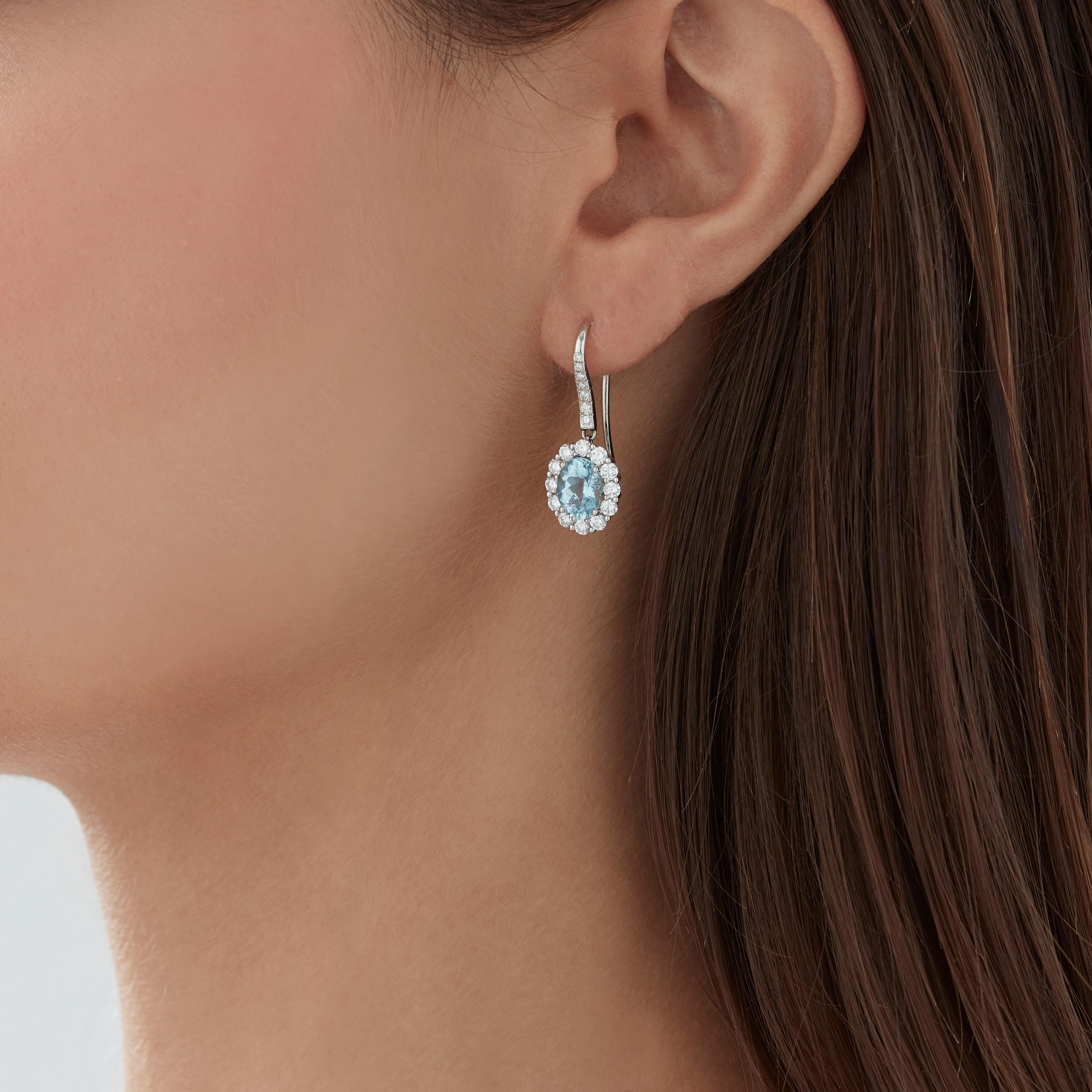 A House of Garrard pair of platinum drop earrings from the 'Garrard 1735' collection, set with central oval aquamarines and round white diamonds.

38 round white diamonds weighing: 1.18cts
2 oval aquamarines approx 8x6mm

The House of Garrard is the