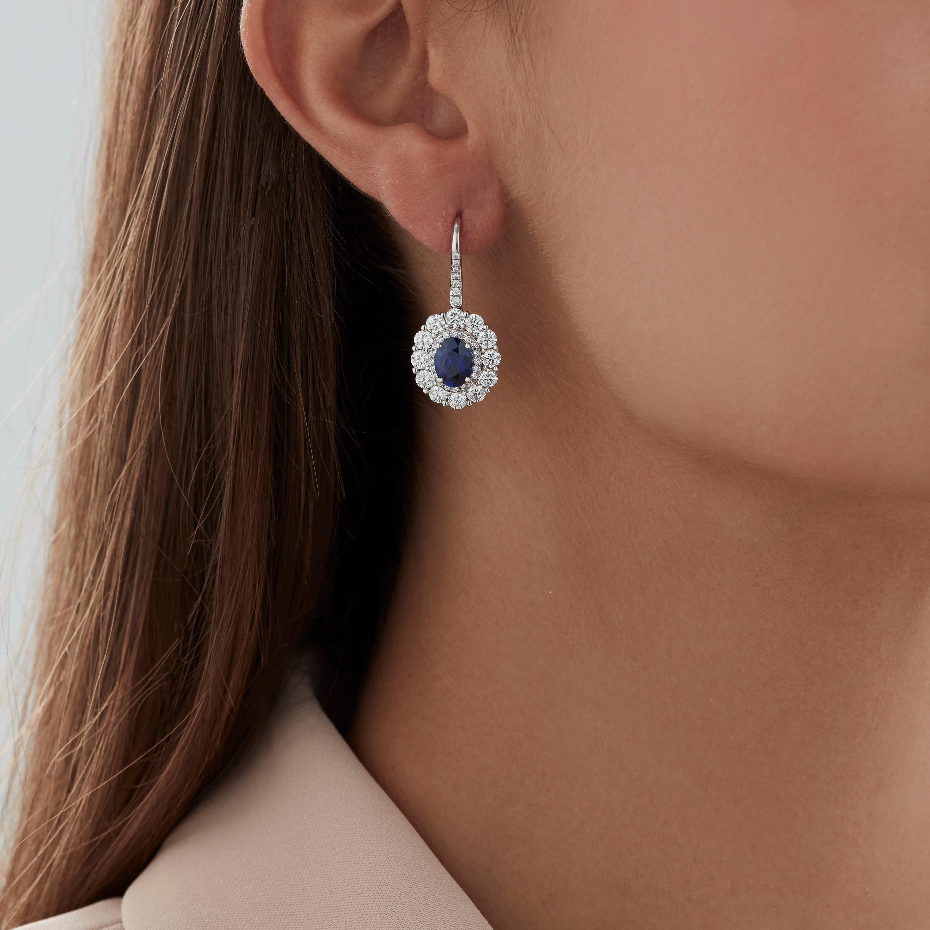 A House of Garrard pair of platinum double cluster drop earrings from the 'Garrard 1735' collection, set with round white diamonds and two central oval blue sapphires.

78 round white diamonds weighing: 2.90cts
1 oval blue sapphire weighing: