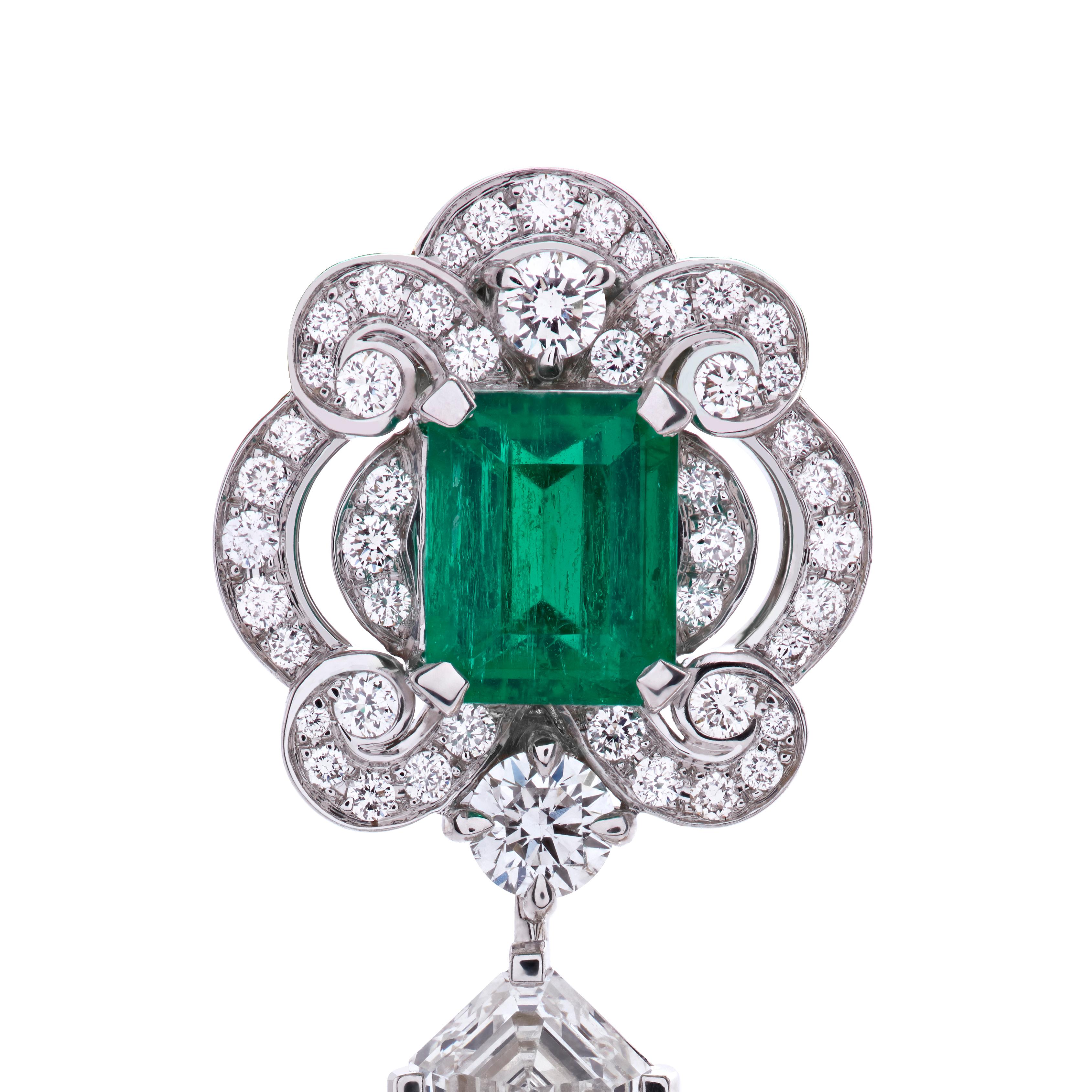 A pair of 18 karat white gold earrings from the House of Garrard. The earrings are set with central Gubelin certified emerald cut emeralds weighing 1.61 carat and 1.67 carat, GRS certified pearshape emeralds weighing 1.42 carat and 1.51 carat and 46