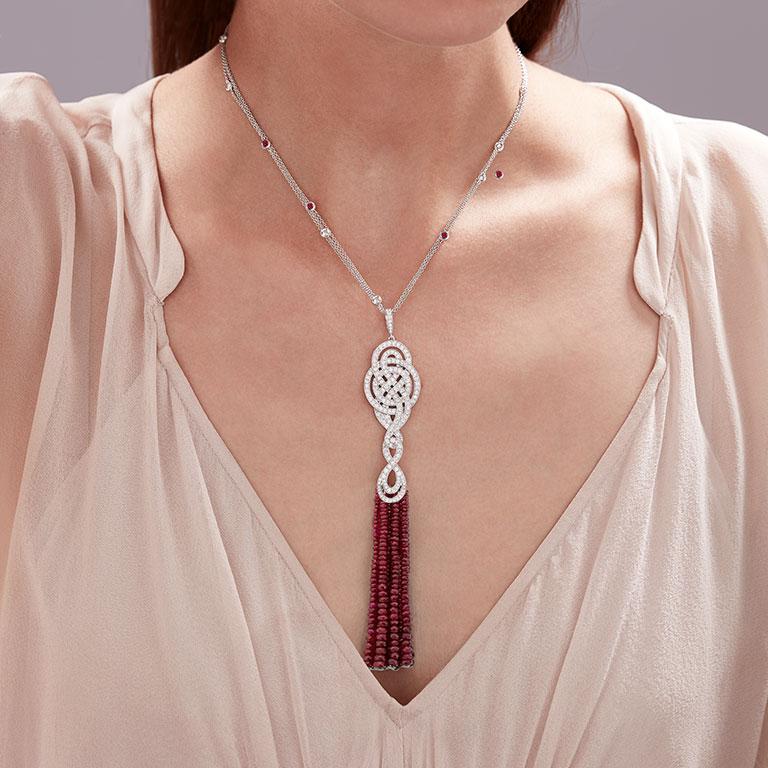 A House of Garrard 18 karat white gold tassel drop pendant pendant from 'Entanglement' collection, set with faceted ruby beads, round rubies and round white diamonds.

14 strands of faceted ruby beads
28 round rubies weighing: 1.23cts
174 round