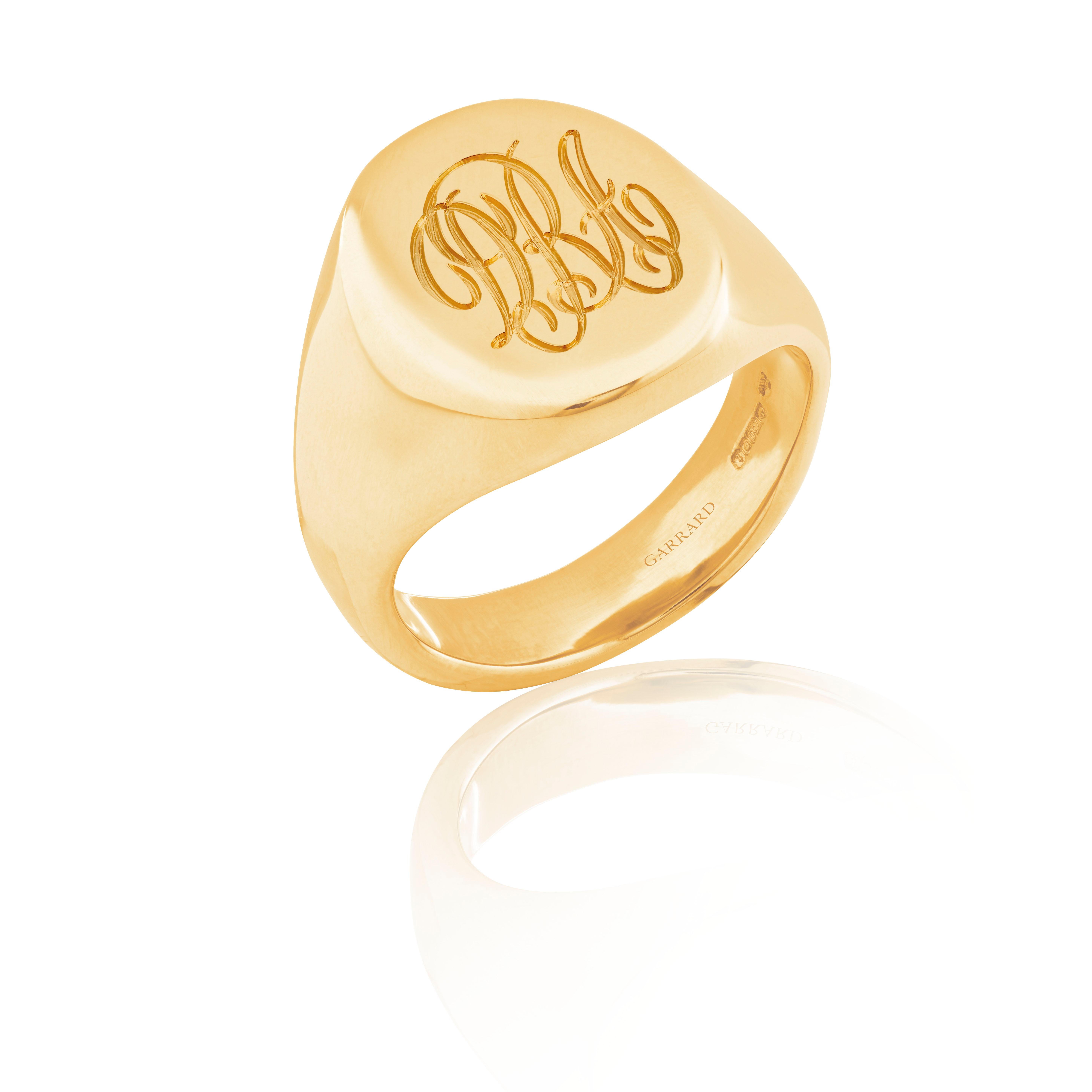 A House of Garrard 18 karat yellow gold medium oval signet ring.

Head dimension: 14mm x 12mm
Size 52

Complimentary engraving of up to three initials in a script font is included. Please allow an additional two weeks to the standard shipping and