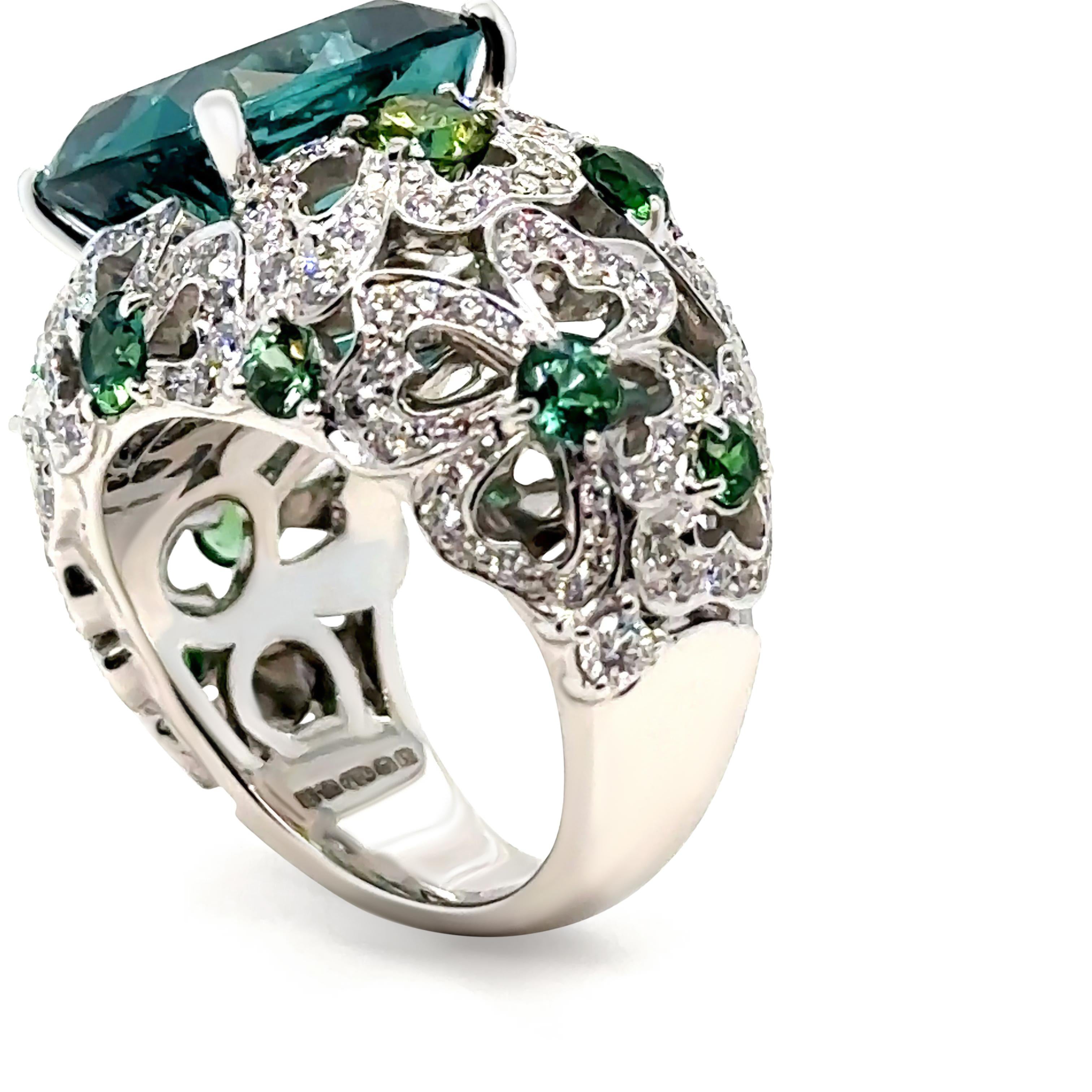 An extraordinary creation by the House of Garrard, this 18ct white gold Bombé cocktail ring from the Tudor Rose collection is a masterpiece of design and craftsmanship. At its center lies a magnificent 8.48ct cushion-cut green tourmaline, certified