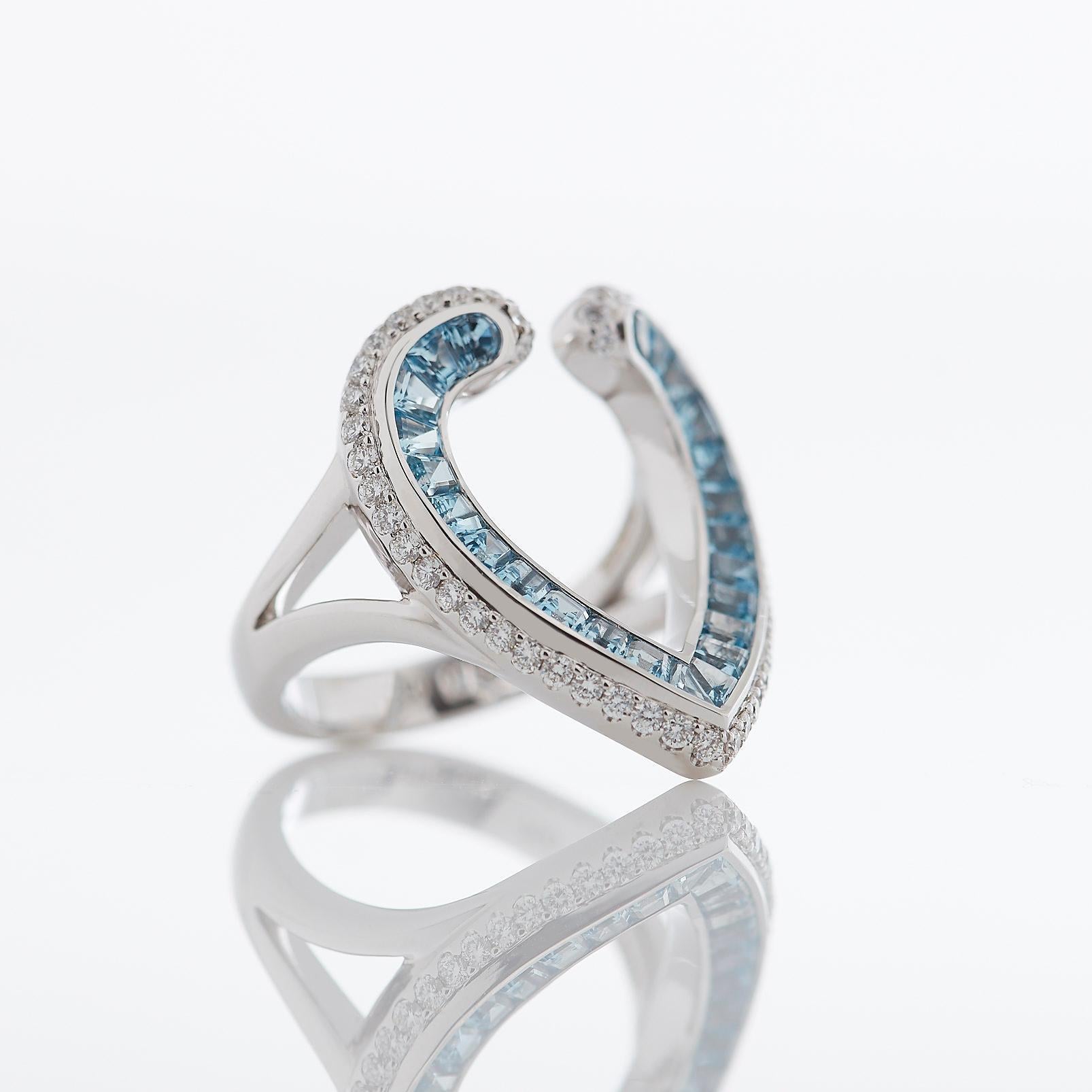 A House of Garrard 18 karat white gold ring from the 'Aloria' collection, set with round white diamonds and calibre cut aquamarines. 

50 round white diamonds weighing: 0.53cts 
24 calibre cut aquamarines weighing: 1.10cts 
Size 54

Please note