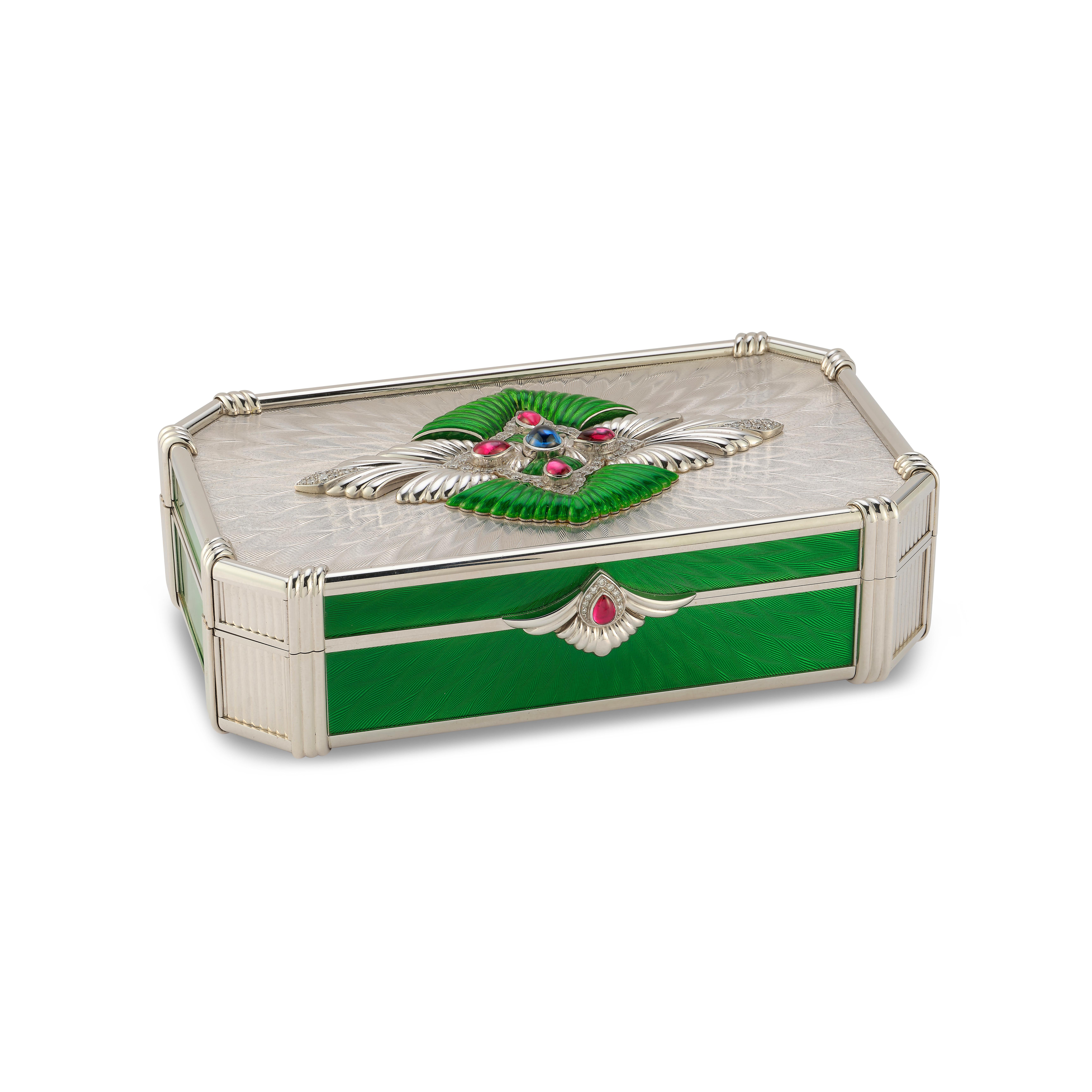 Garrard & Co. Enamel and Gem Set Box -

An 18 karat white gold box with green enamel set with a cabochon sapphire, 5 cabochon rubies, and 75 round diamonds weighing approximately 1.8 carats

Signed G & Co LD
Stamped 750

Measurements: 5.75