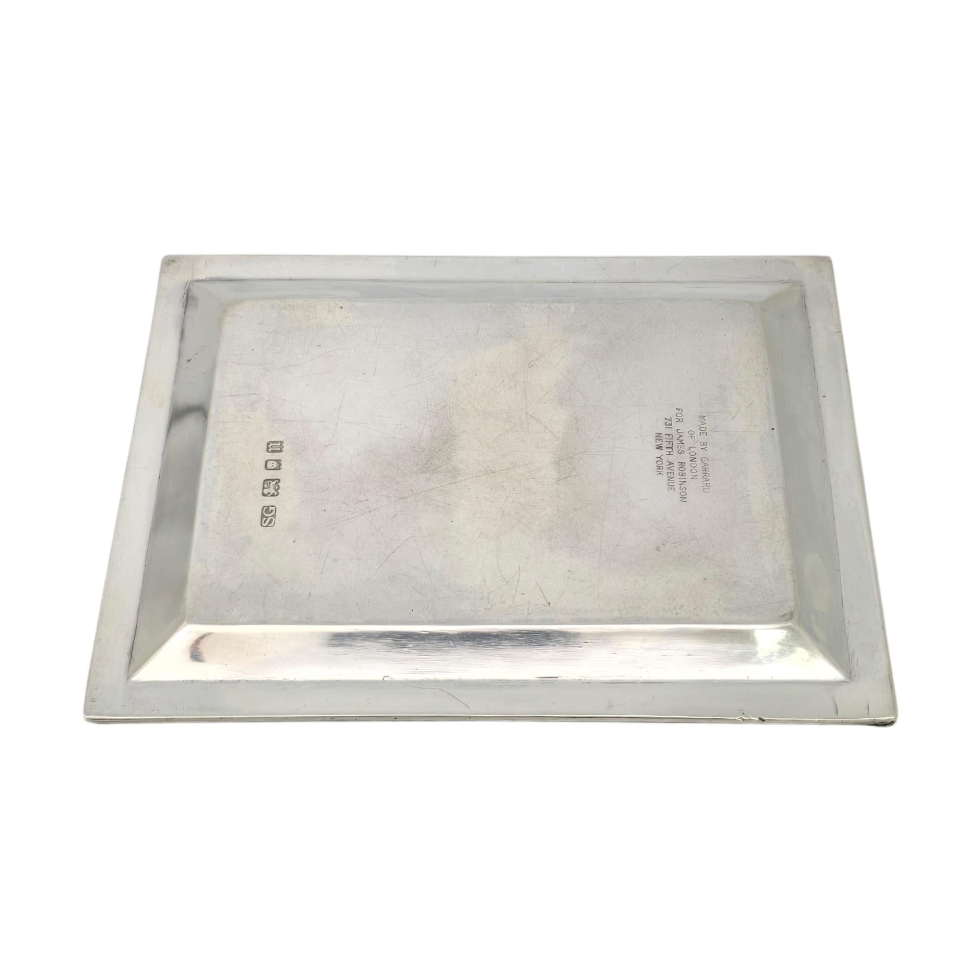 Vintage sterling silver small tray by Garrard & Co Ltd of London, England for James Robinson of NY, NY with monogram, circa 1928.

Monogram appears to be LSF

A small rectangular trinket tray featuring ribbed accent edge with a monogram at its