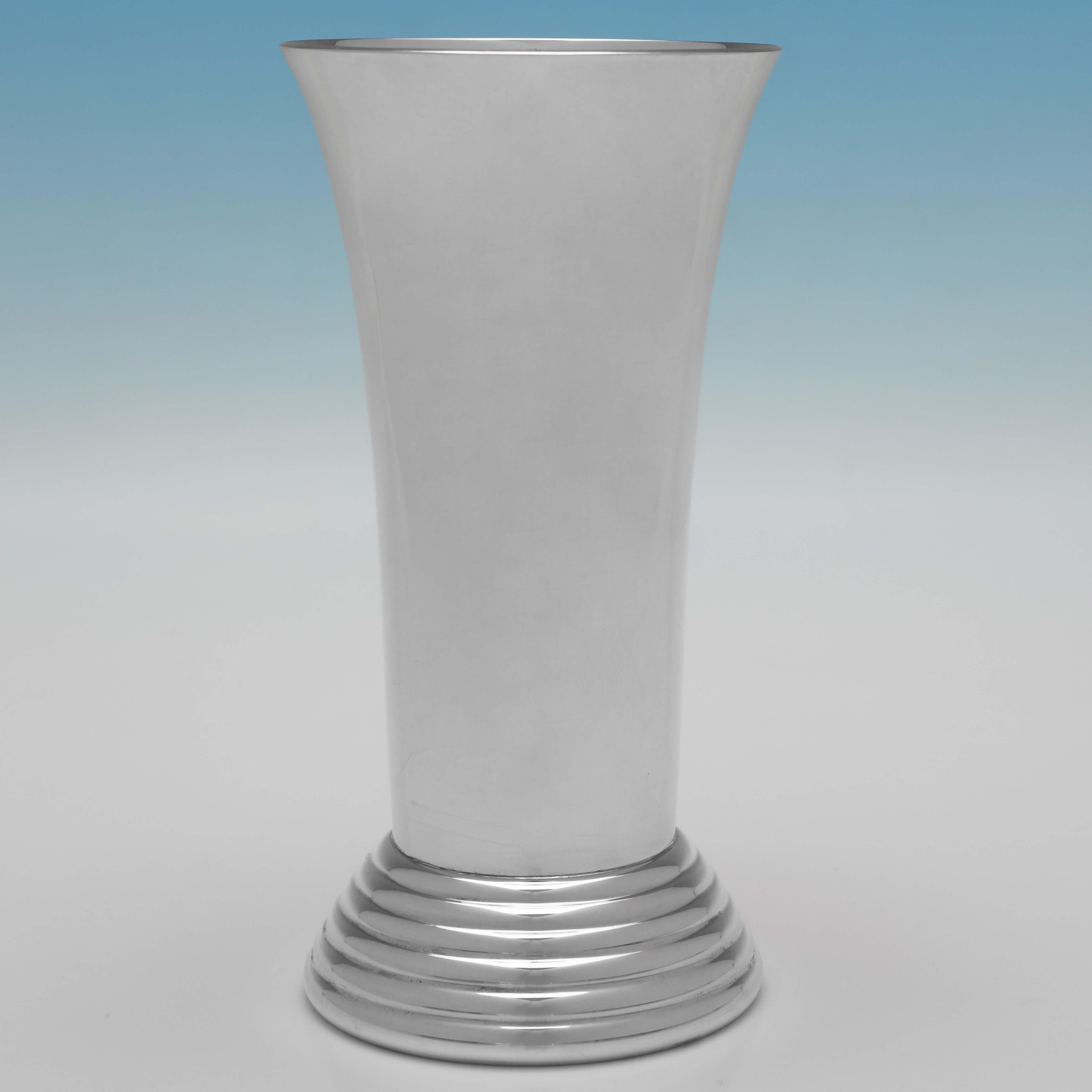 Hallmarked in London in 1997 by Gerrard & Co., this handsome, Sterling Silver Vase, is plain in design, and stands on a stepped base. 

The vase measures 6