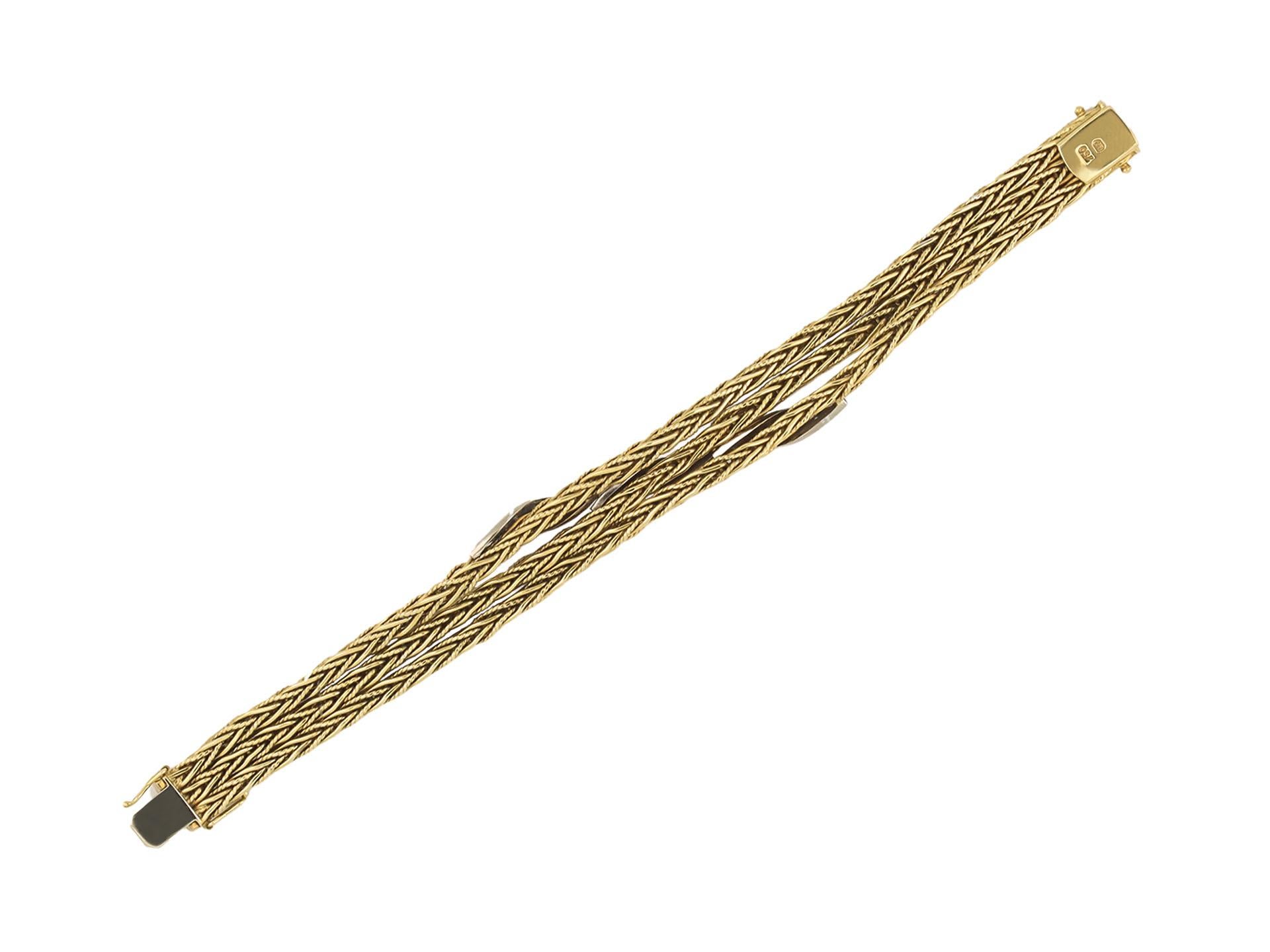 Garrard Diamond Bracelet. Set throughout with 54 round eight cut diamonds in open back grain settings with a combined approximate total weight of 1.10 carats, flowing through to three articulated yellow gold rope chains comprising of four