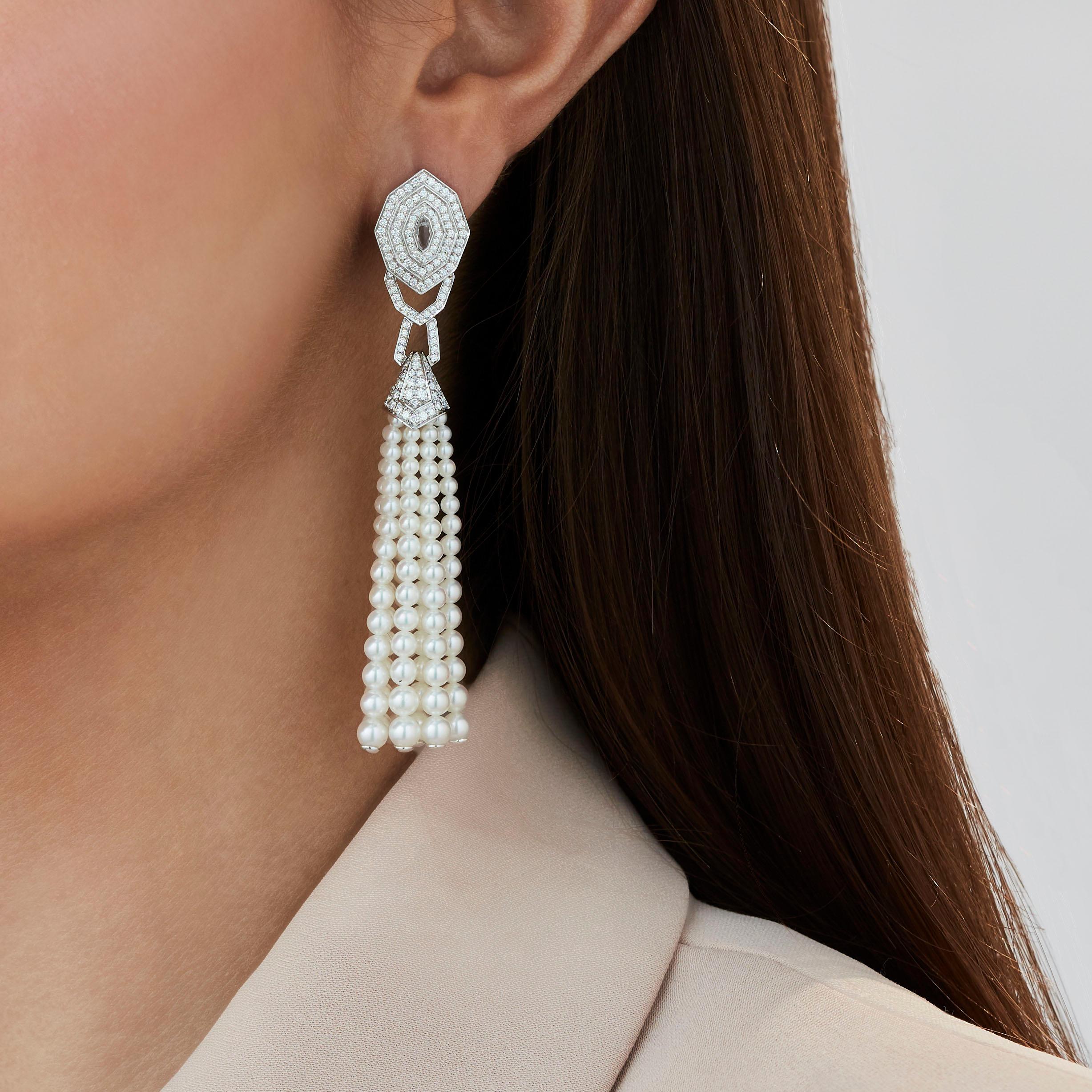A House of Garrard pair of 18 karat white gold tassel earrings from the 'Enchanted Palace' collection, set with round white diamonds, white cultured pearls and rock crystals.

258 round white diamonds weighing: 1.38cts
14 strands of white cultured