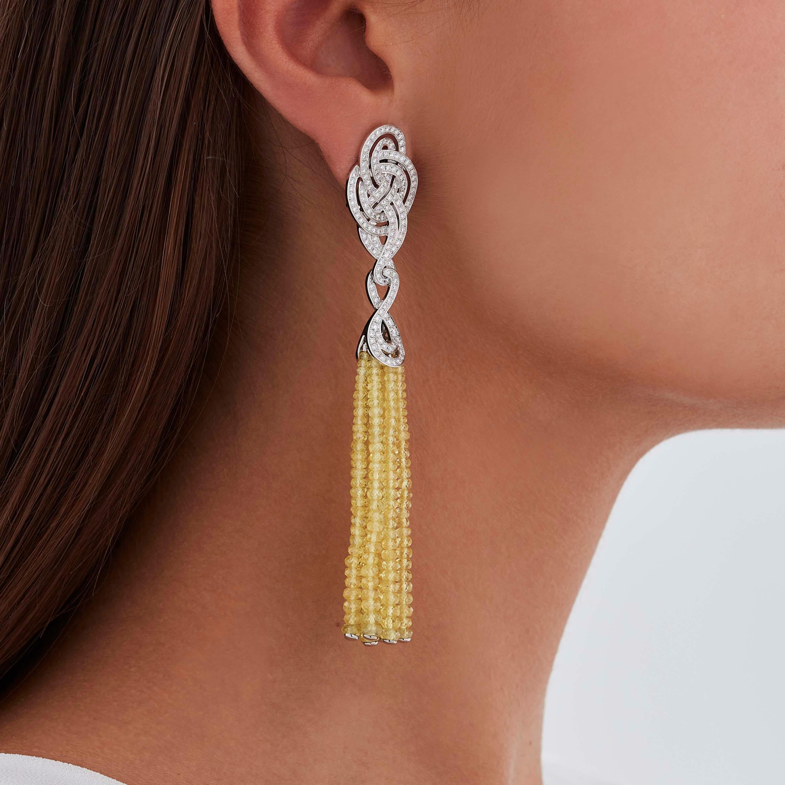 A House of Garrard pair of 18 karat white gold tassel earrings from the 'Entanglement' collection, set with round white diamonds and faceted yellow sapphire beads. 

284 round white diamonds weighing: 2.04cts
18 strands of faceted yellow sapphire