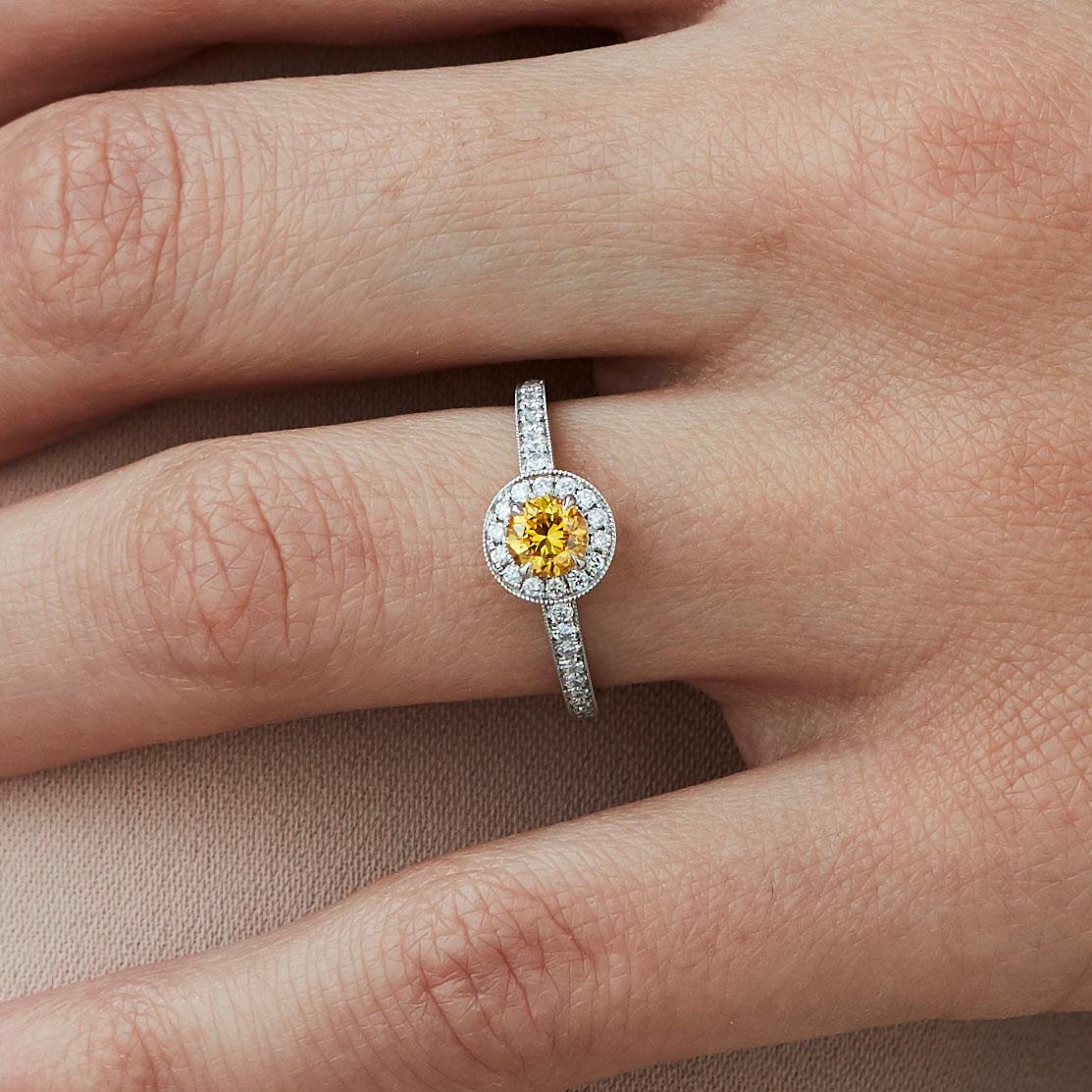 A House of Garrard platinum ring from the 'Garrard Evermore' collection, set with round white diamonds and a central round yellow diamond.

1 round yellow diamond weighing: 0.43cts
GIA certified, Fancy Vivid Yellow
36 round white diamonds weighing: