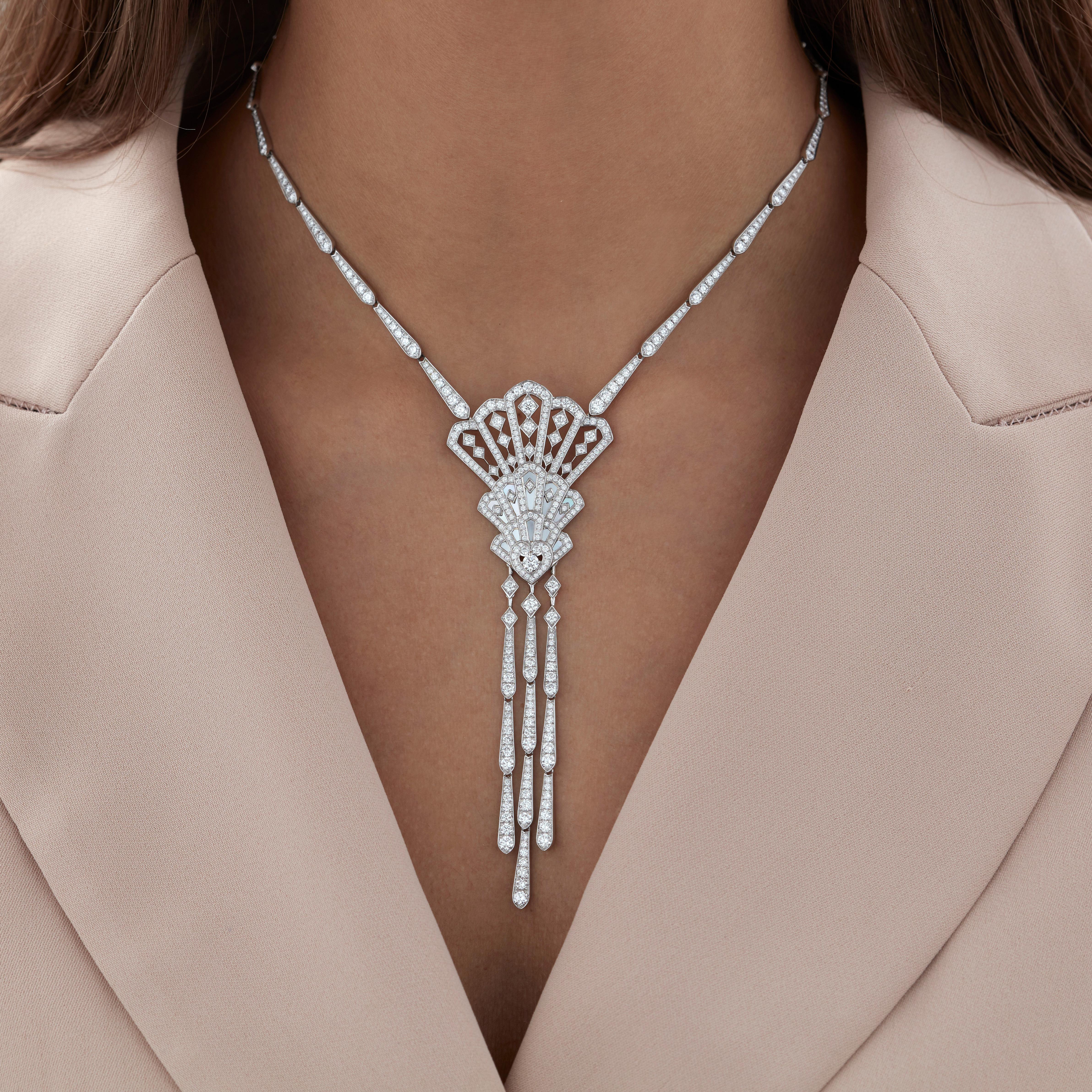 A House of Garrard 18 karat white gold necklace from the 'Fanfare Cascade' collection, set with round white diamonds and white mother of pearl.

461 round white diamonds weighing: 8.11cts
16 pieces of white mother of pearl

The House of Garrard is