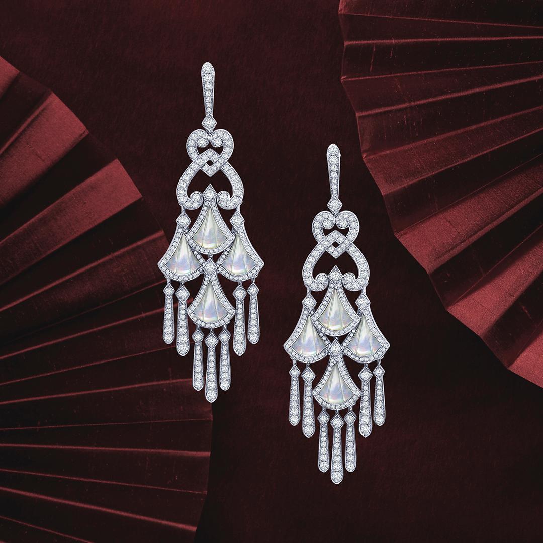 The perfect bridal gift that is beautiful and elegant. 
A pair of 18 karat white gold chandelier earrings from The House of Garrard Fanfare collection, set with round white diamonds and calibre cut mother of pearl. The chandelier motif measures