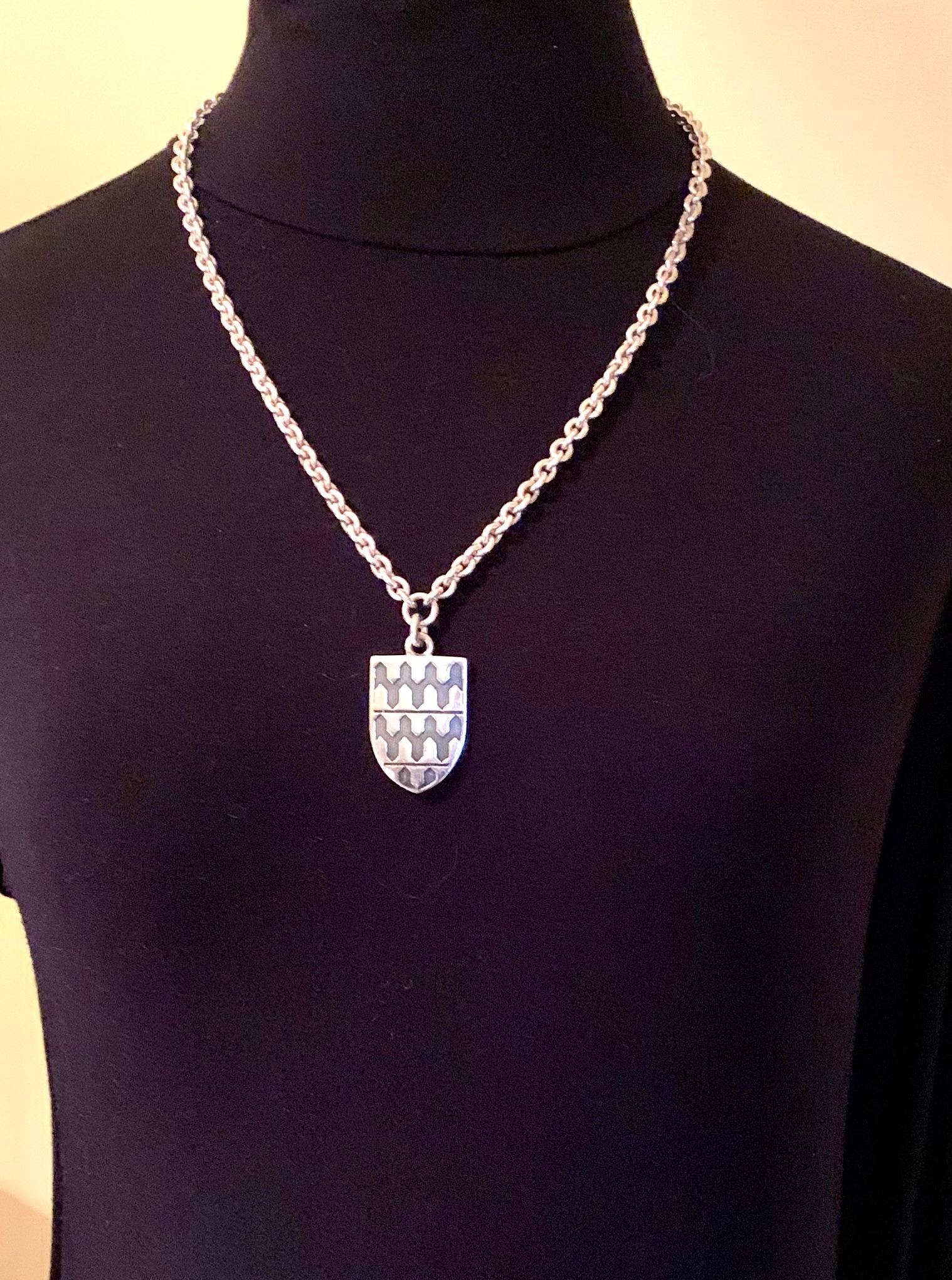Rare estate Garrard substantial stering silver Georgian style armoreal shield pendant necklace 
Provenance: from the estate of a notable New York City psychiatrist and collector of unusual, often one of a kind jewels
Garrard has represented the very