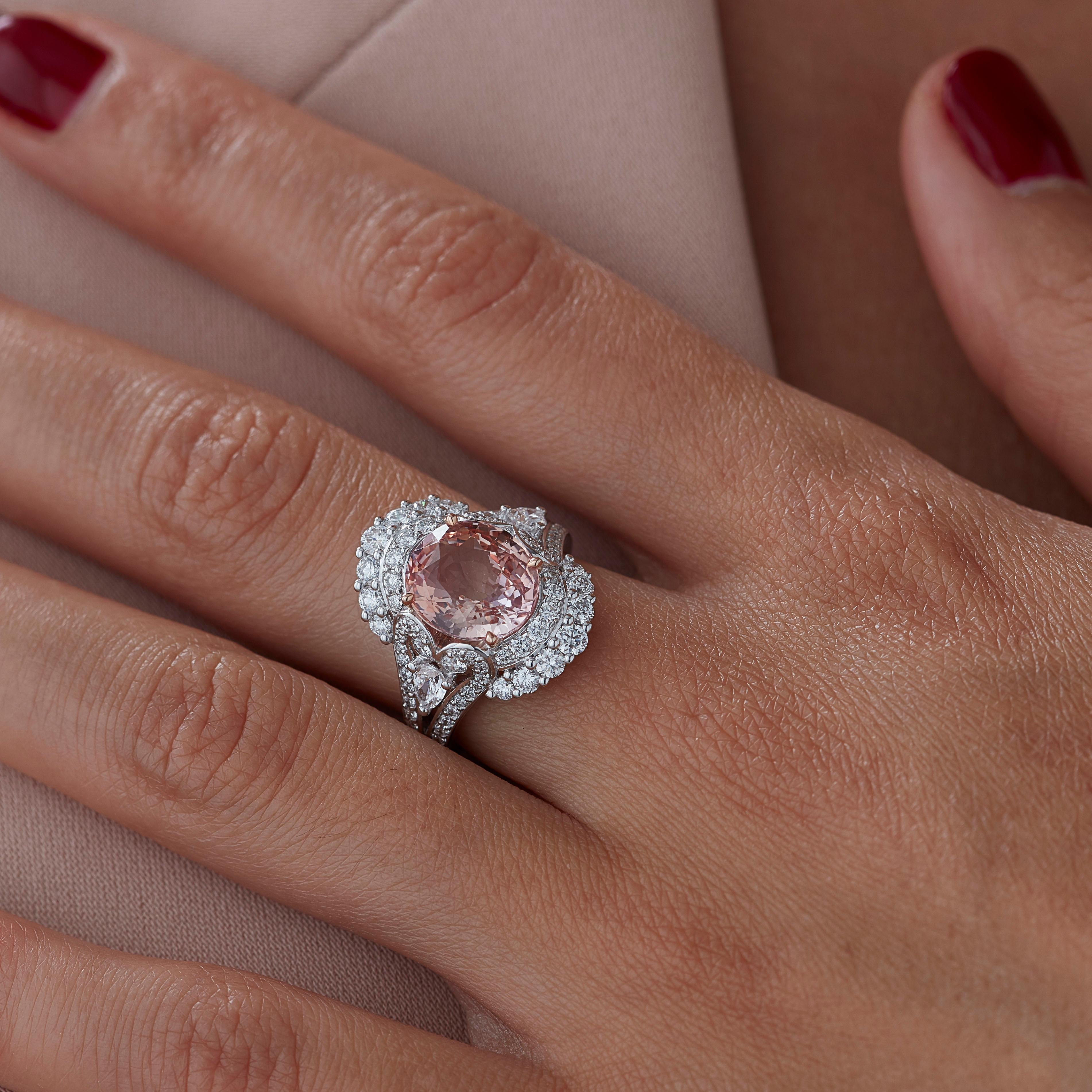 A House of Garrard 18 karat white gold 'Jewelled Vault' ring, set with a central oval padparadscha sapphire and round and pearshape white diamonds.

1 oval padparadscha sapphire weighing: 5.54cts 
GRS certified, Sri Lanka, Orange-Pink, Unheated
86