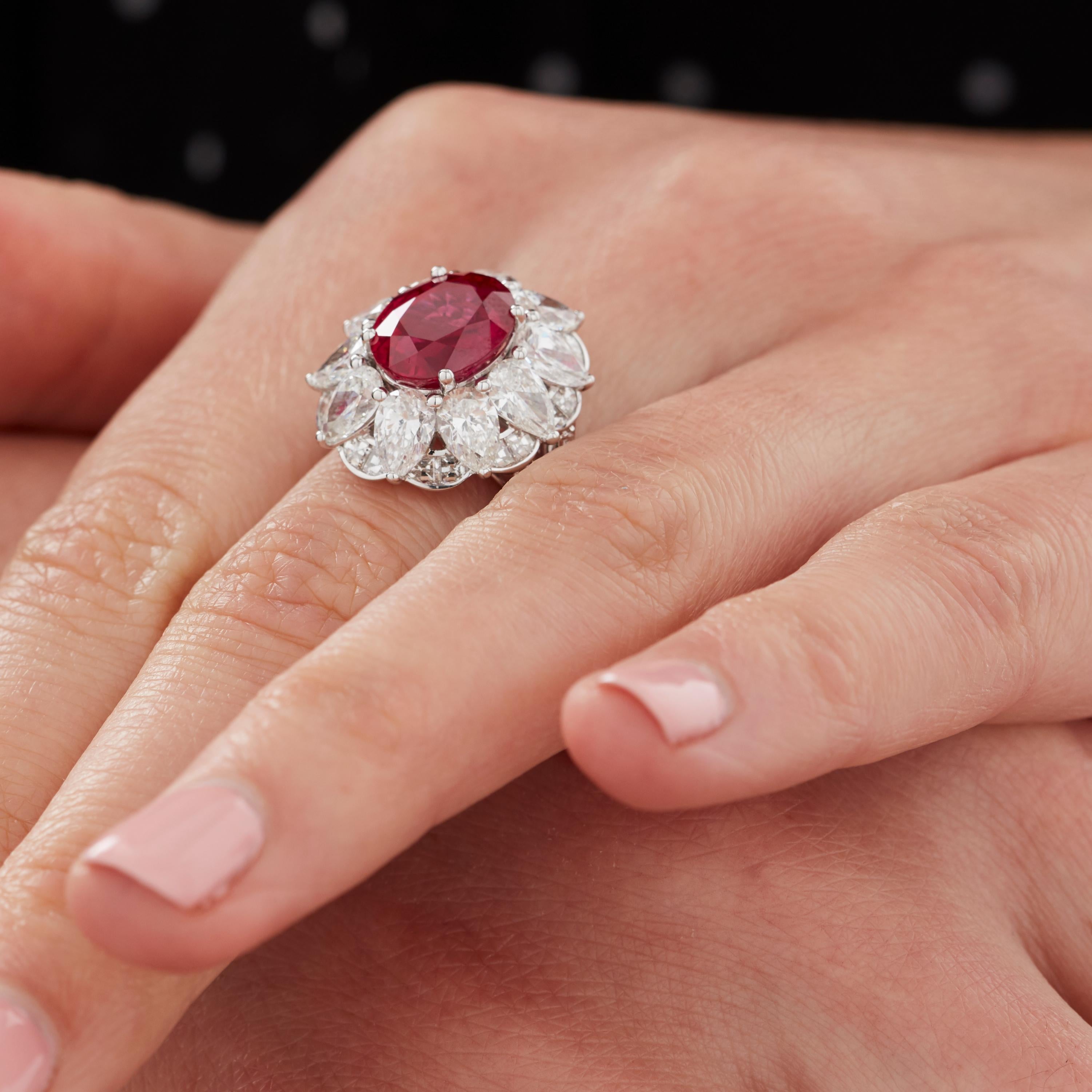 A House of Garrard 18 karat white gold 'Jewelled Vault' ring, set with round white diamonds and a central oval ruby.                                                                            

66 round white diamonds weighing 5.18ct                