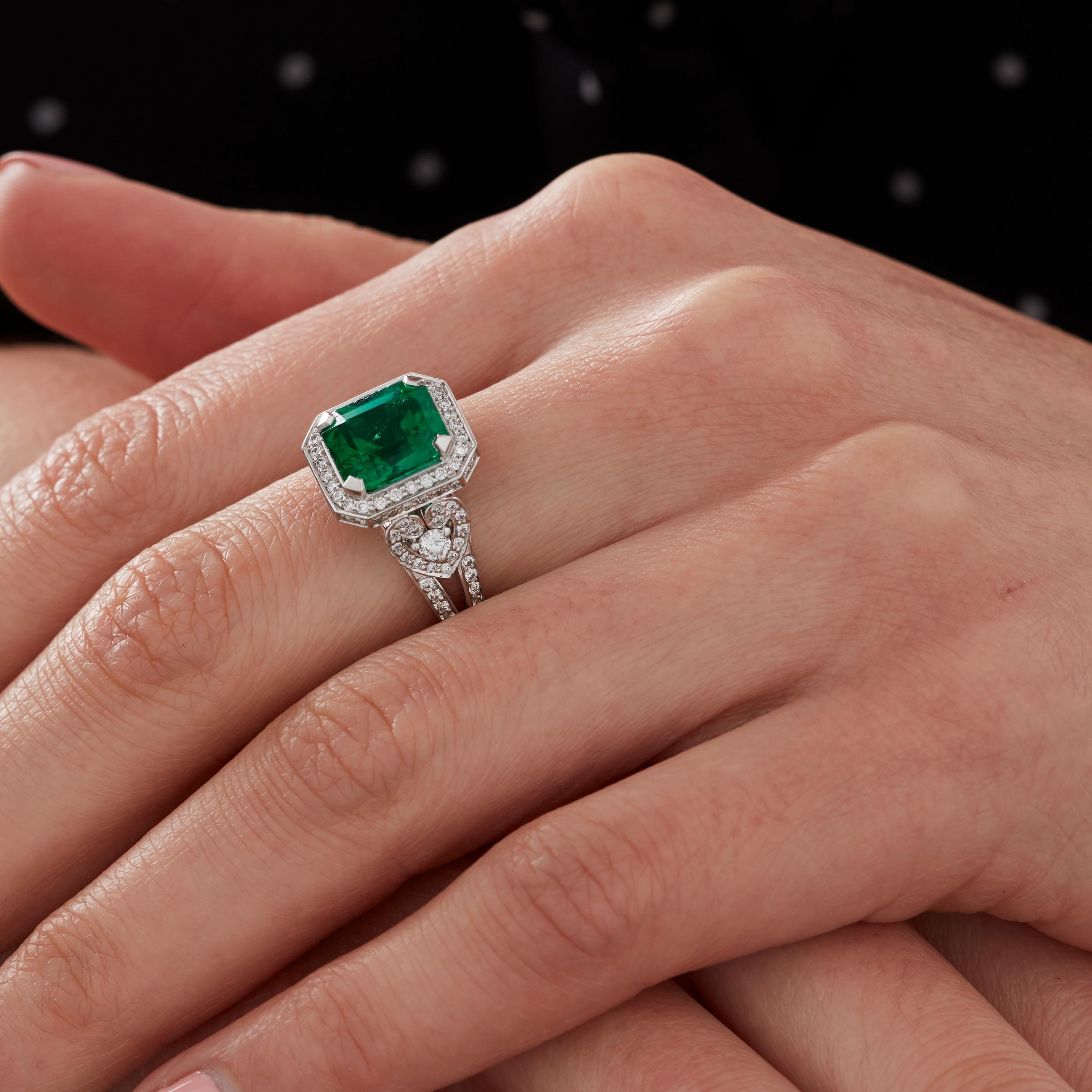 A House of Garrard 'Jewelled Vault' 18 Karat ring, set with round white diamonds and a central Columbian emerald cut emerald.

1 emerald cut emerald weighing: 3.03cts                                                                                   