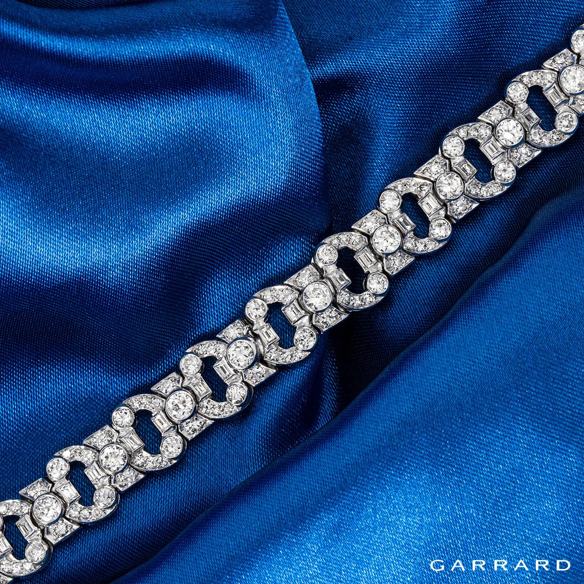A magnificent platinum diamond bracelet by Garrard. This bracelet is meticulously crafted with 15 round brilliant cut diamonds bezel set through the centre with an approximate total weight of 2.45ct, E-F colour and VS-SI clarity. Further