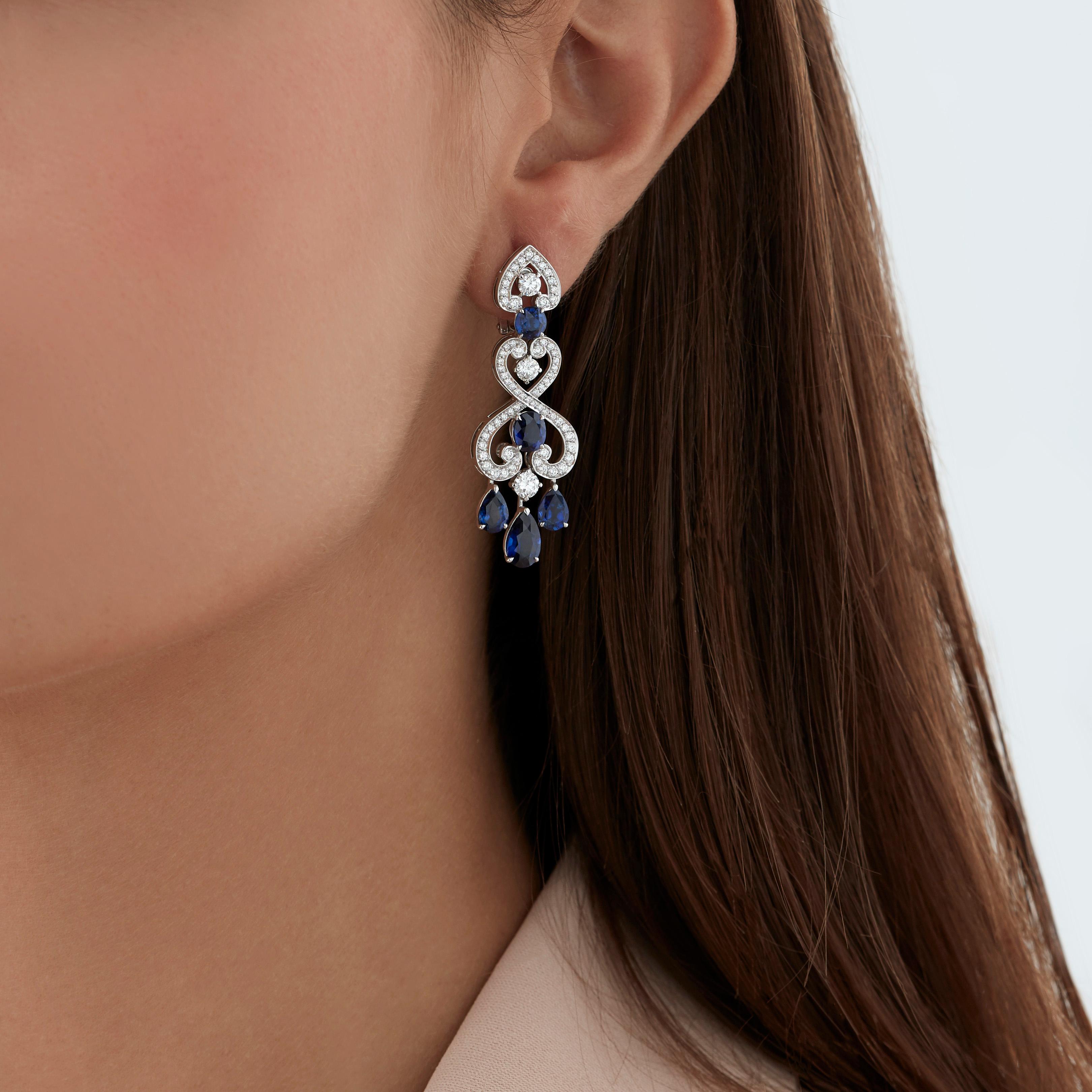 A House of Garrard pair of 18 karat white gold drop earrings from the 'Regal Cascade' collection, set with round white diamonds and round, oval and pearshape blue sapphires.

136 round white diamonds weighing: 1.75cts
2 round blue sapphires