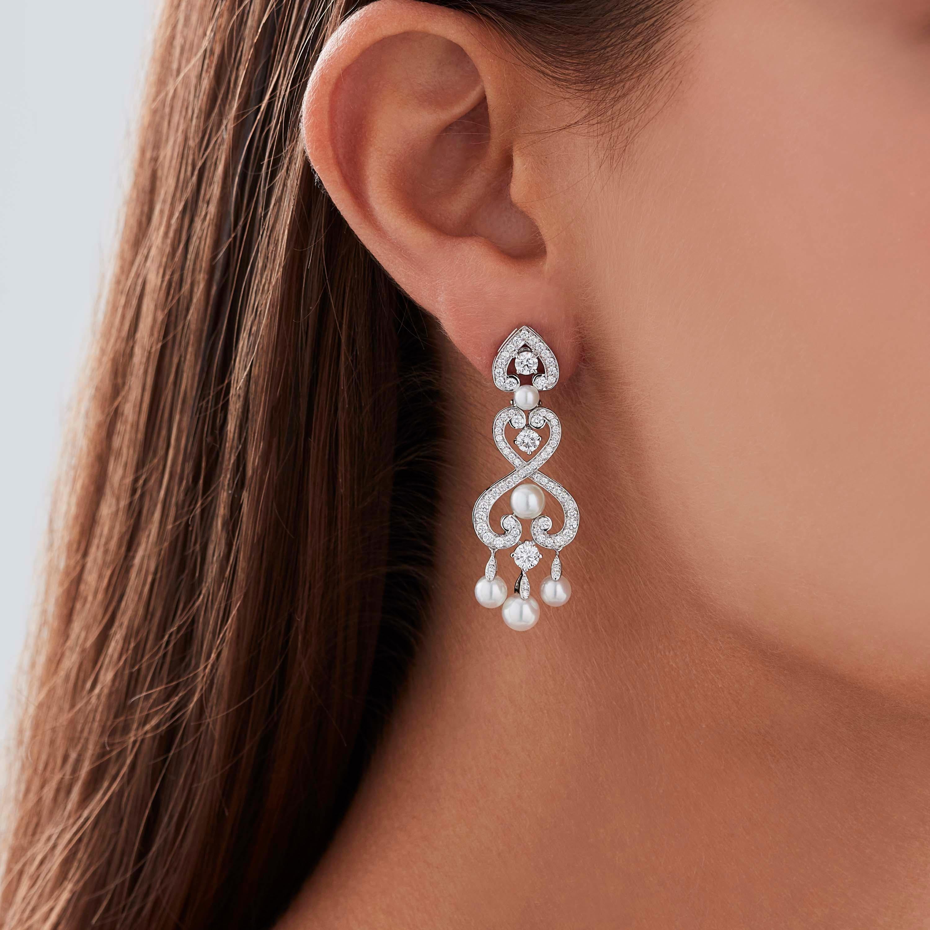 A House of Garrard pair of 18 karat white gold earrings from the 'Regal Cascade' collection, set with round white diamonds and round white cultured pearls. 

154 round white diamonds weighing: 1.81cts
10 round white cultured pearls

The House of