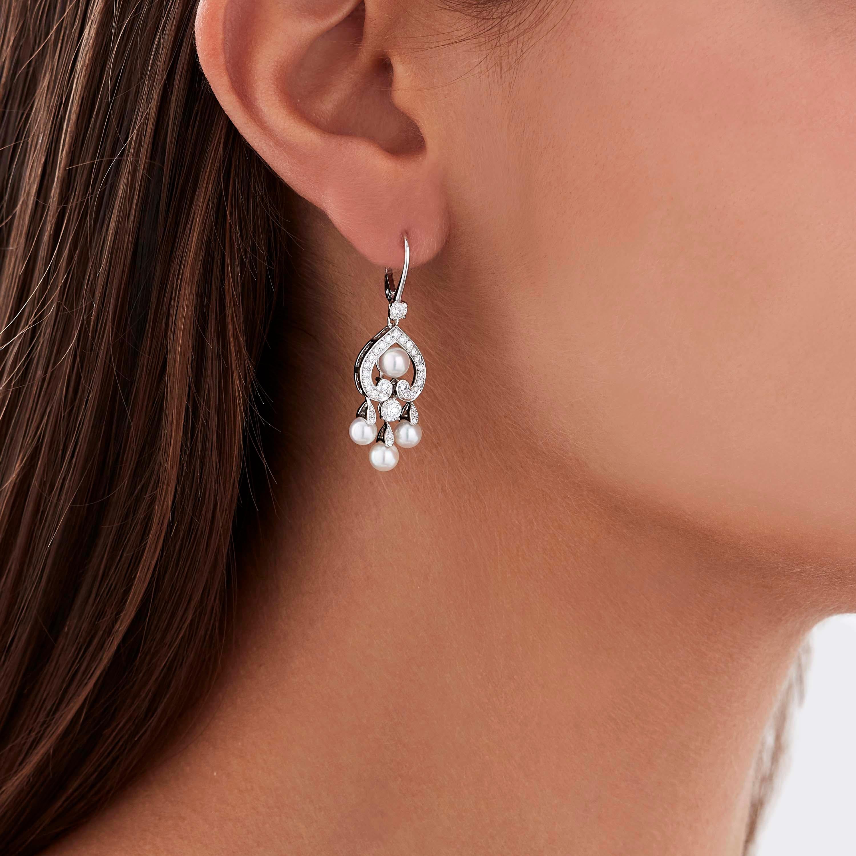 A House of Garrard pair of 18 karat white gold earrings from the 'Regal Cascade' collection, set with round white diamonds and round white cultured pearls. 

68 round white diamonds weighing: 0.93cts
8 round white cultured pearls

The House of
