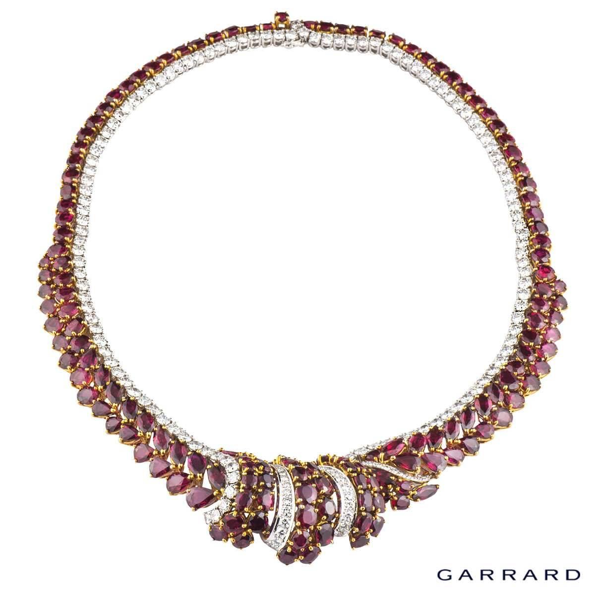 An exquisite ruby and diamond necklace by Garrard c.1996. The centre of the necklace features a graduated scroll design and is comprised of 151 rubies, each intricately set in 18k yellow gold. The rubies are a mix of round, pear, oval and marquise