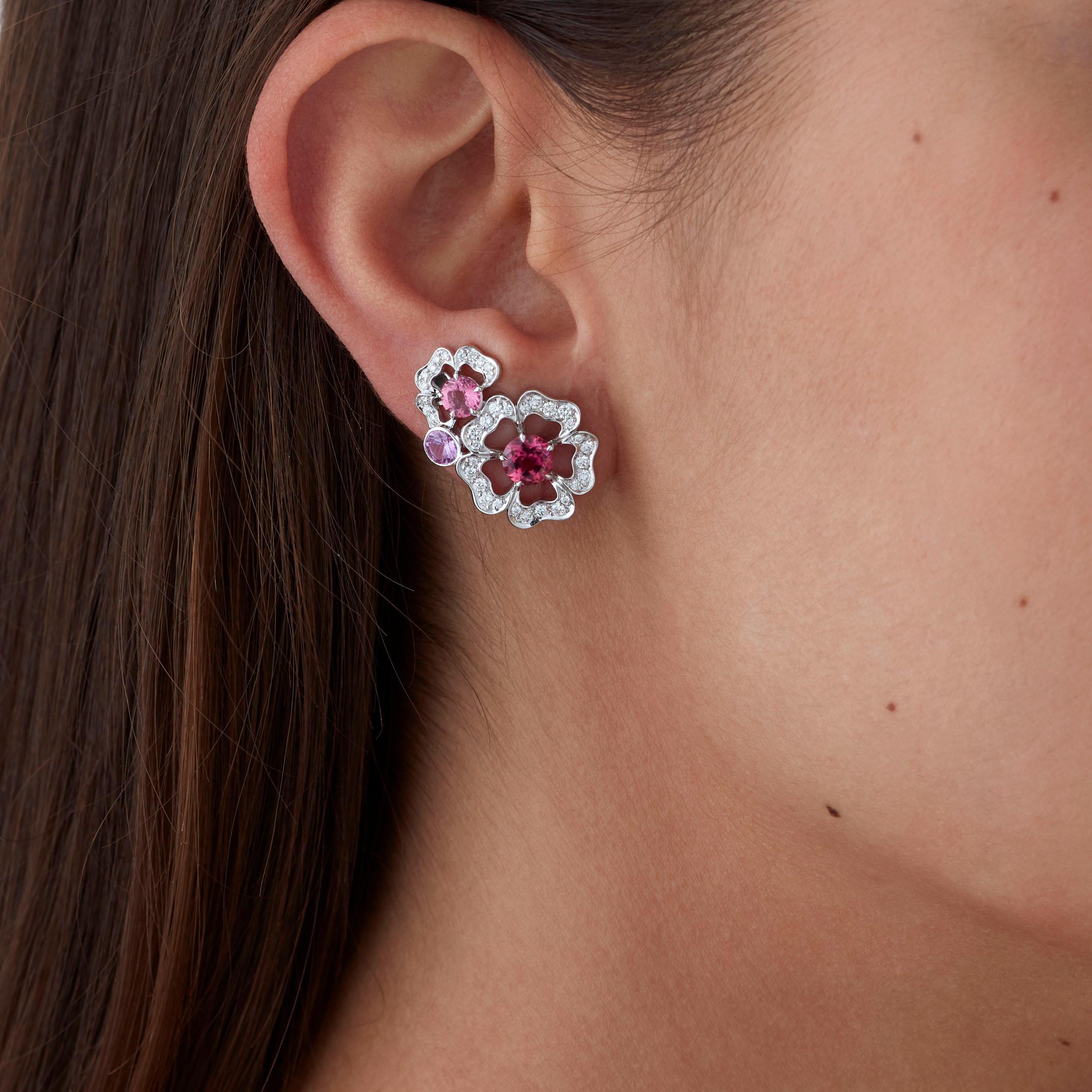 A House of Garrard pair of 18 karat white gold ear climbers from the 'Tudor Rose Petal' collection set with tourmalines, pink sapphires, rubellites and round white diamonds. 

2 round rubellites weighing: 1.22cts
2 round pink tourmalines weighing: