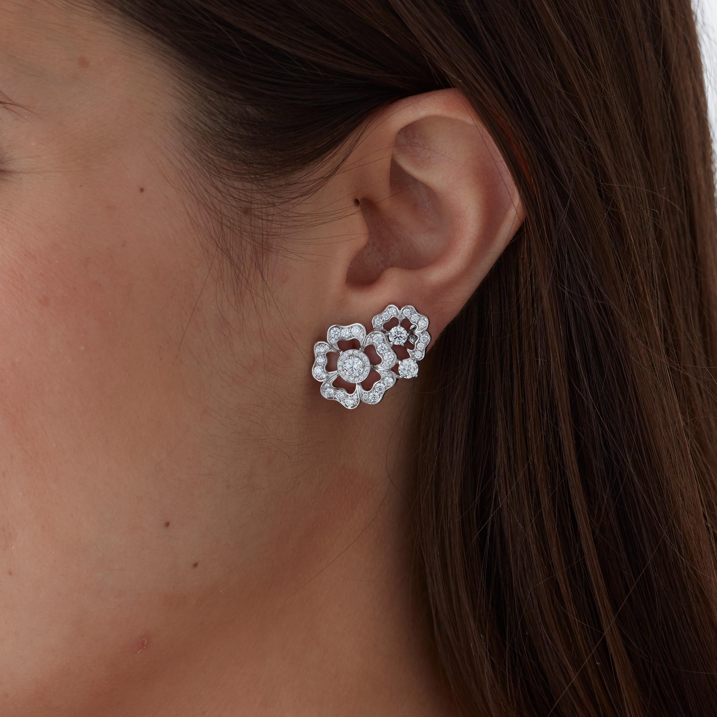 A House of Garrard pair of 18 karat white gold ear climbers from the 'Tudor Rose Petal' collection, set with round white diamonds.

112 round white diamonds weighing: 2.09cts                                                                           
