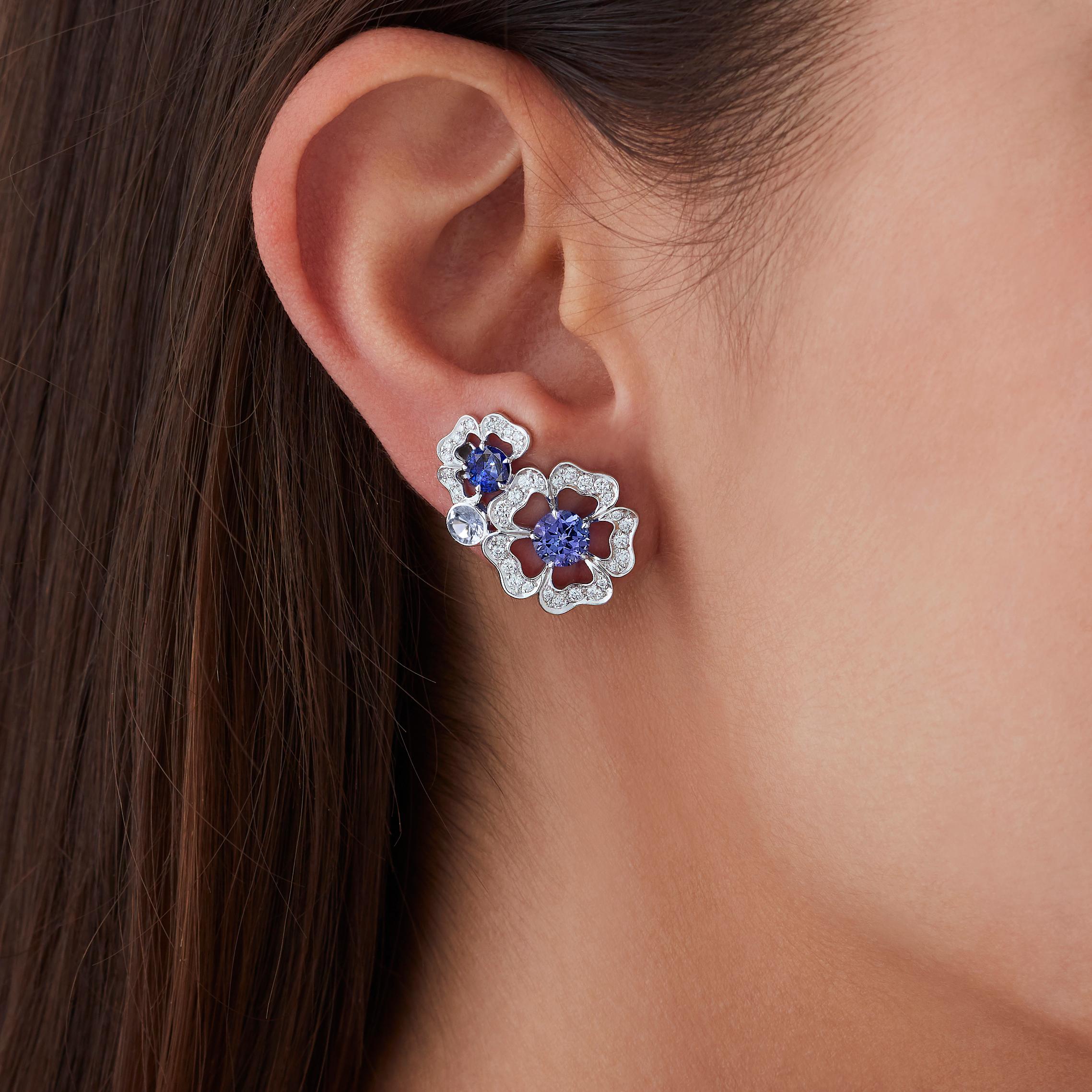 A House of Garrard pair of 18 karat white gold ear climbers from the 'Tudor Rose Petal' collection set with blue sapphires, tanzanites and round white diamonds.
                                                                                        