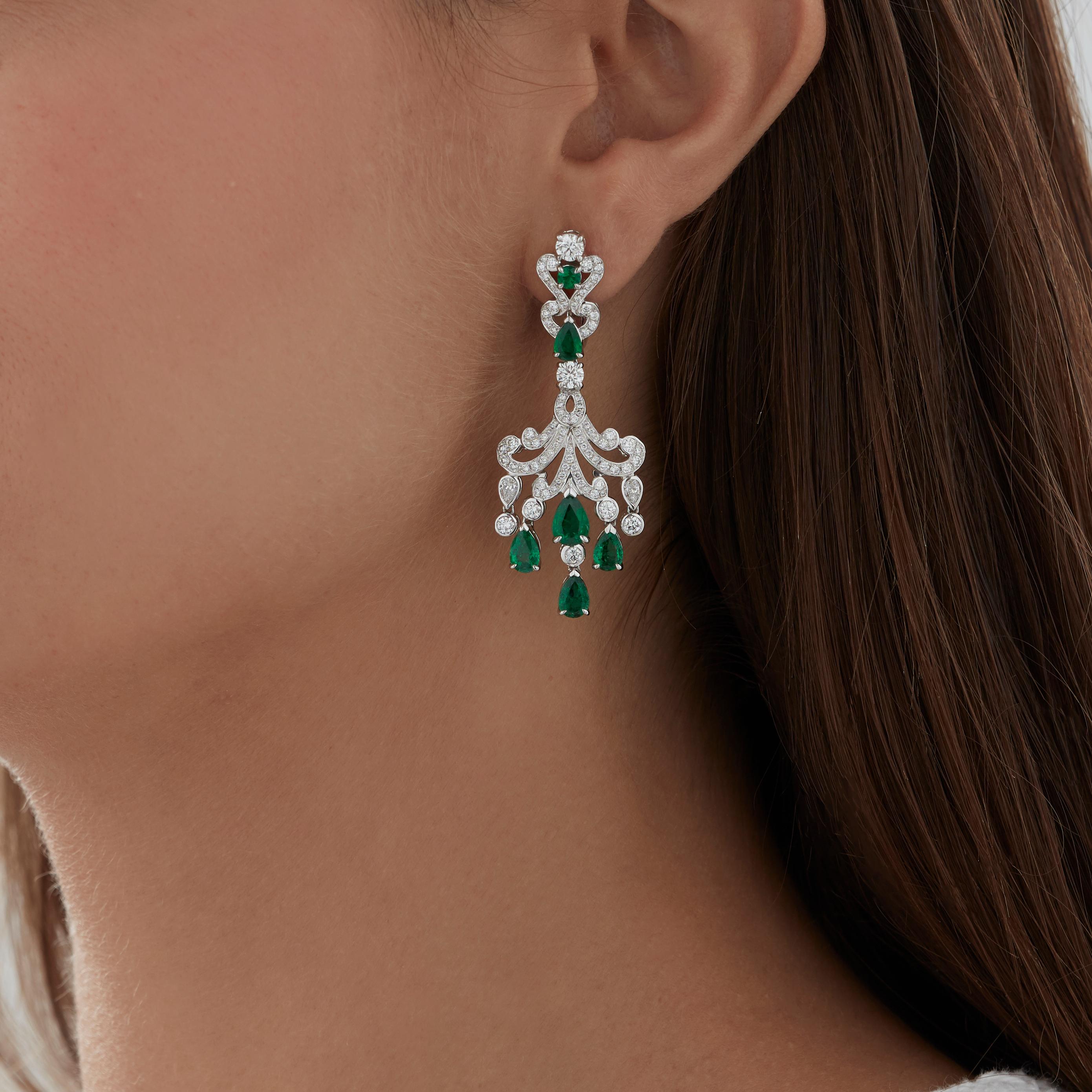 A House of Garrard pair of 18 karat white gold 'Waterlily' drop earrings, set with white diamonds  and round and pearshape emeralds.

178 white diamonds weighing 2.50cts
2 round emeralds weighing: 0.23cts
10 pearshape emeralds weighing: