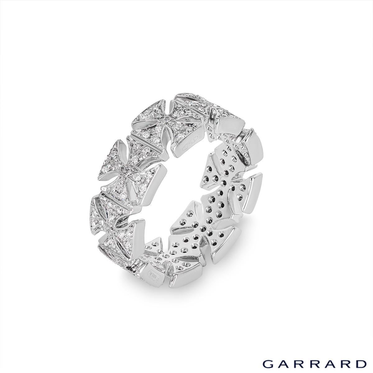 A unique 18k white gold diamond full eternity ring by Garrard. The ring features 9 diamond set cross motifs set throughout to form a full eternity band. The 117 round brilliant cut diamonds have an approximate total weight of 0.46ct, F-G colour and