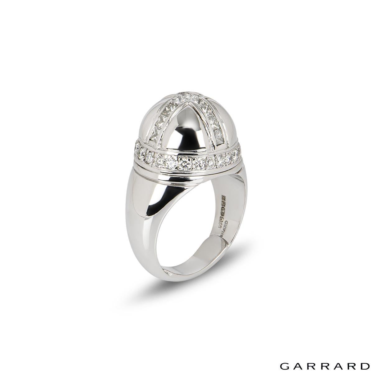 A unique 18k white gold diamond ring from Garrard. The dome shaped ring is set with princess cut diamonds on the top making a cross and around the sides are round brilliant cut diamonds making the ring a crown style totalling approximately 1.07ct.