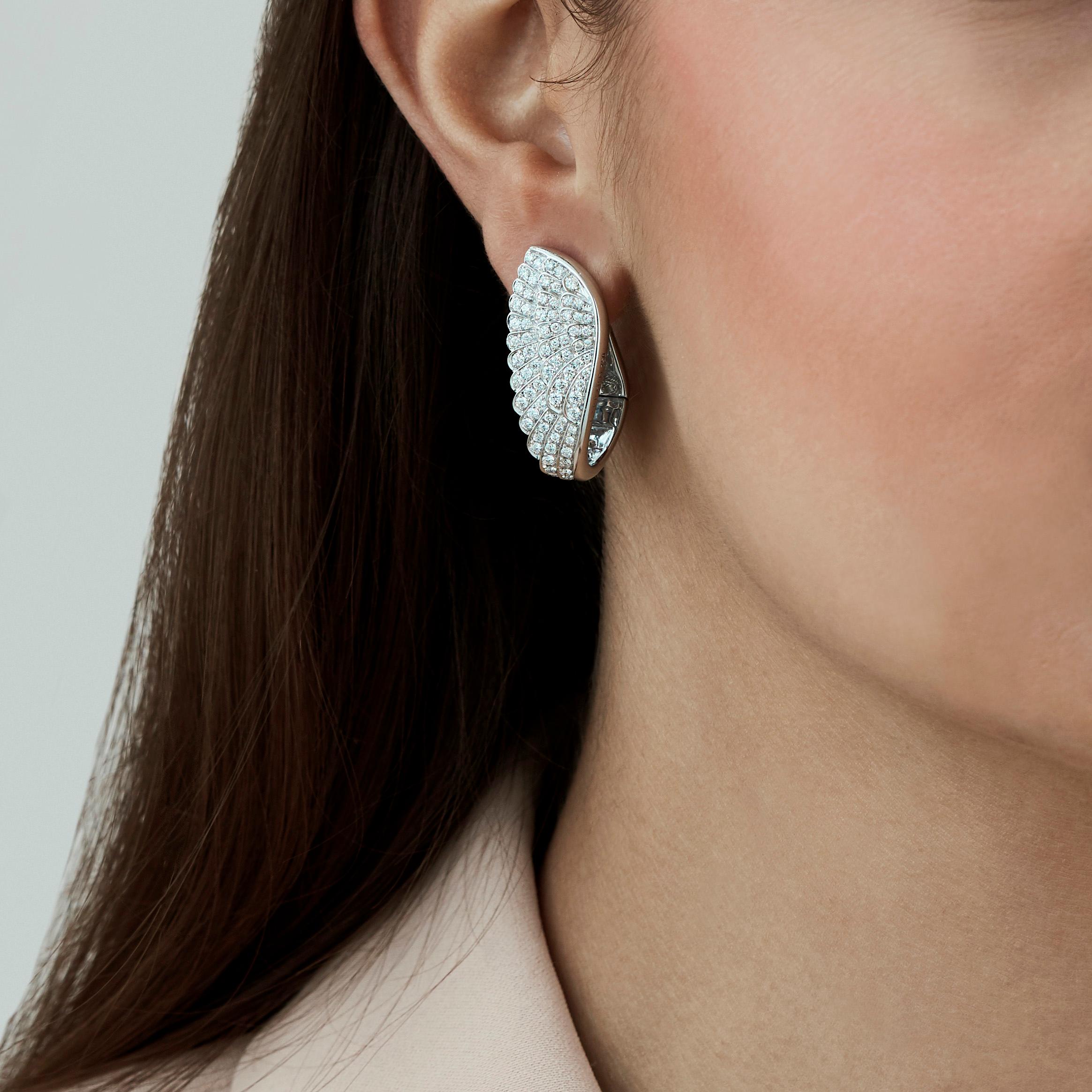 A House of Garrard pair of 18 karat white gold wrap earrings from the 'Wings Classic' collection, set with round white diamonds.

216 round white diamonds weighing: 0.55cts

The House of Garrard is the longest serving jeweller in the world. The