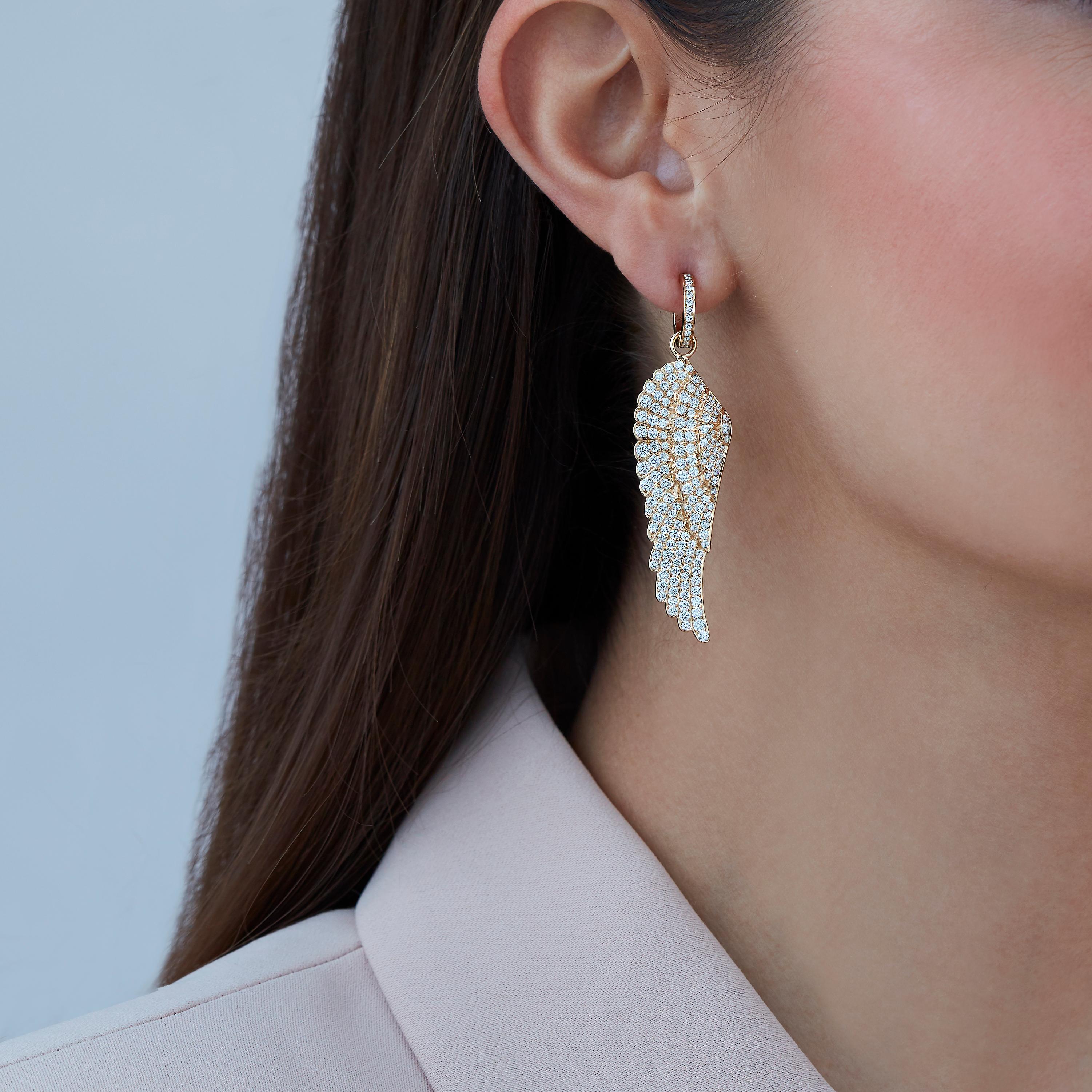 A House of Garrard pair of 18ct yellow gold large hoop and drop earrings from the 'Wings Classic' collection, set with round white diamonds. 

328 round white diamonds weighing: 4.19cts

The House of Garrard is the longest serving jeweller in the