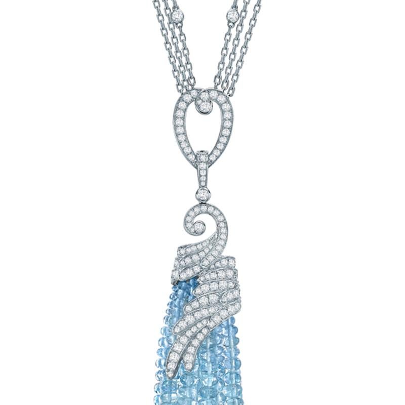 An 18 karat white gold and aquamarine tassel pendant from The House of Garrard Wings Embrace collection set with 242 polished aquamarine beads weighing 144.01 carats and 151 round white diamonds weighing 2.88 carats. The pendant measures 7cm in