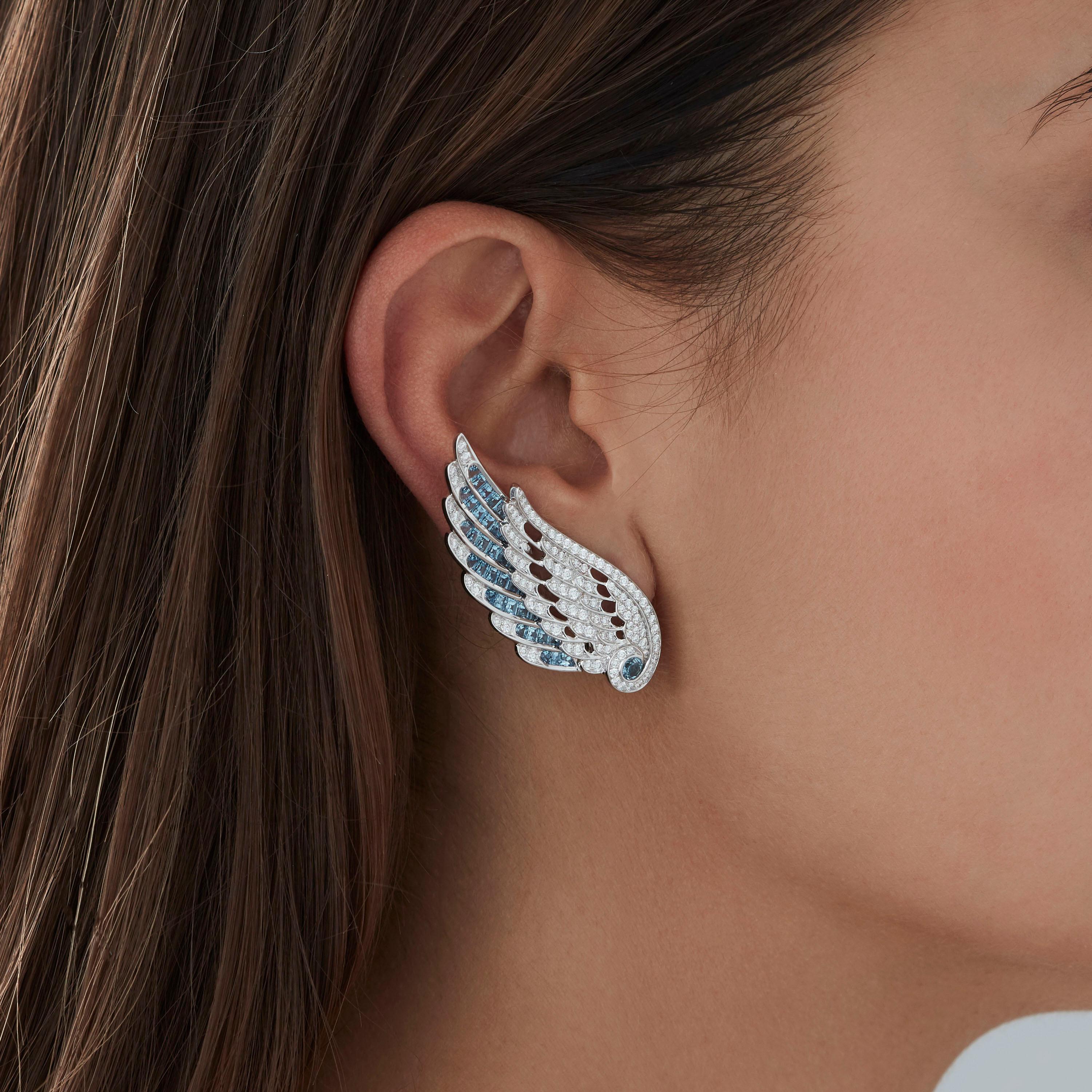 A House of Garrard pair of 18 karat white gold ear climbers from the 'Wings Embrace' collection, set with round and calibre cut aquamarines and round white diamonds.

222 round white diamonds weighing: 1.76cts
90 calibre cut aquamarines weighing: