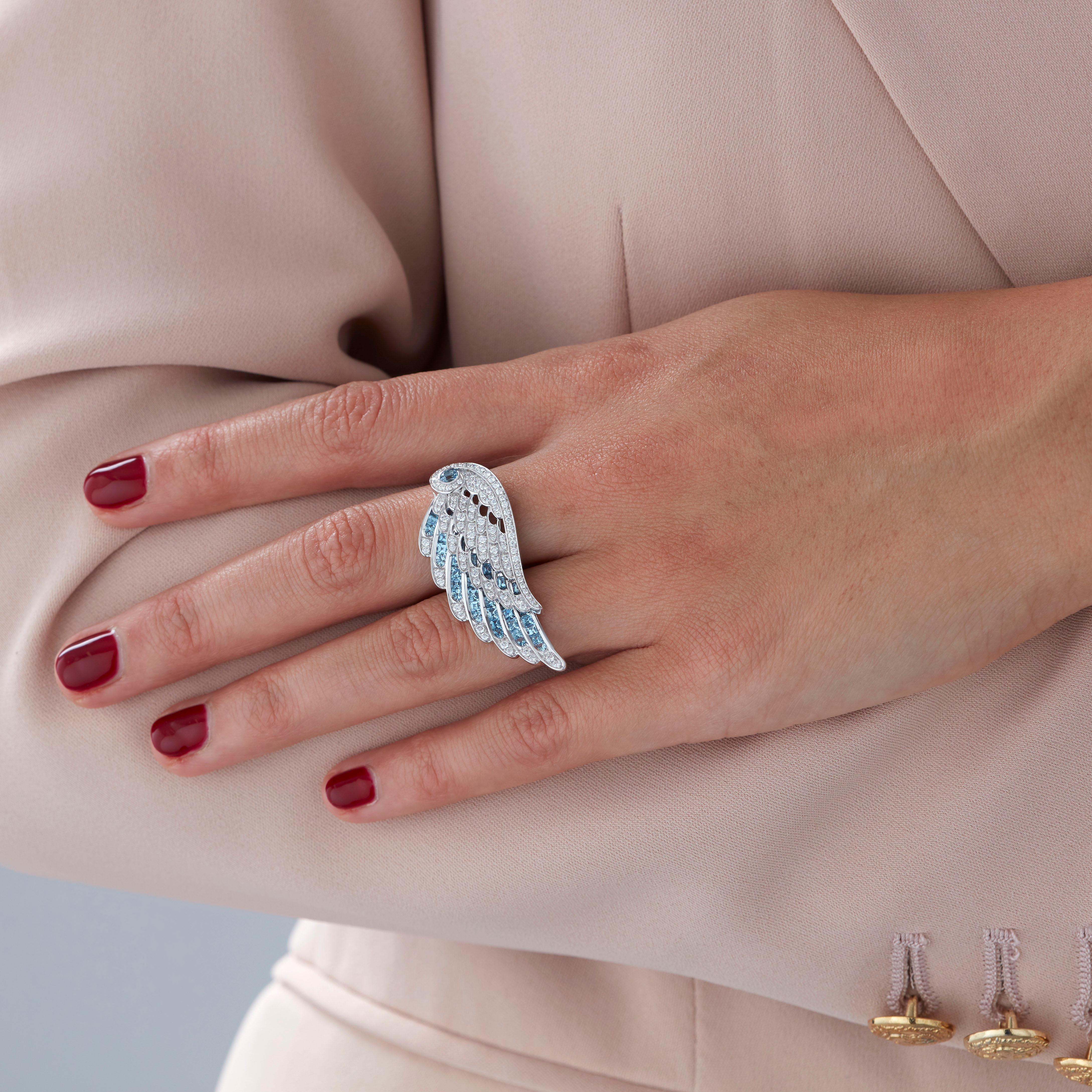 A House of Garrard 18 karat white gold ring from the 'Wings Embrace' collection, set with round white diamonds and round and calibre cut aquamarines. 

106 round white diamonds weighing: 0.78cts
1 round aquamarine weighing: 0.13cts
42 calibre cut
