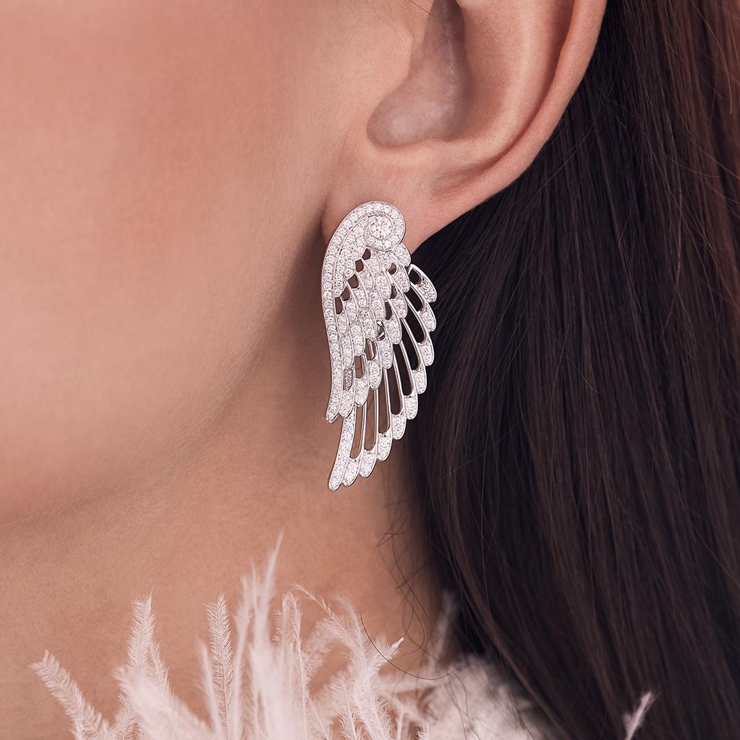 A House of Garrard pair of 18 karat white gold double motif drop earrings from the 'Wings Embrace' collection, set with round white diamonds. The earring measures 4.3cm in length.

264 round white diamonds weighing: 2.16cts

The House of Garrard is