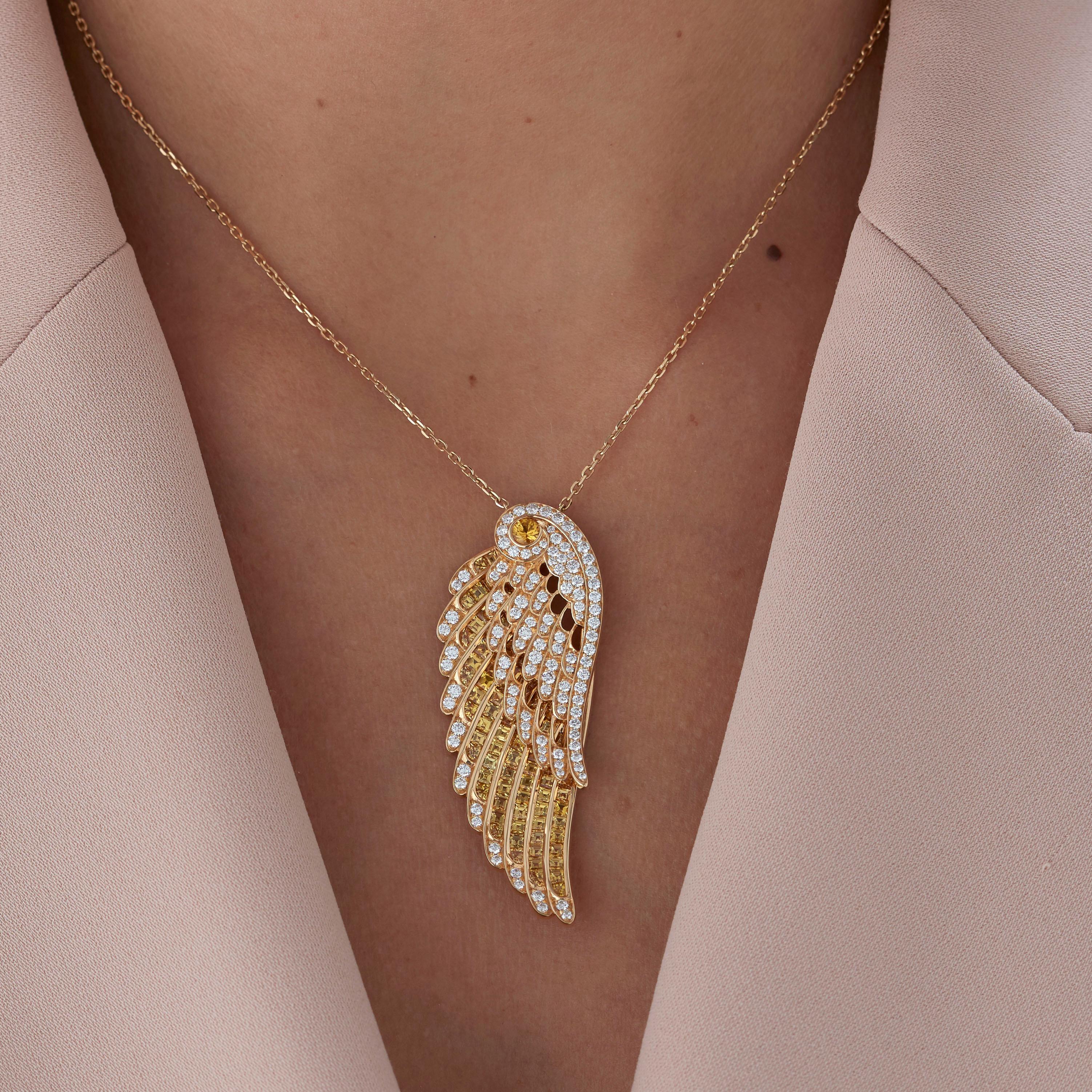 A House of Garrard 18 karat yellow gold slider pendant from the 'Wings Embrace' collection with a double wing motif, set with round white diamonds and round and calibre cut yellow sapphires.

150 round white diamonds weighing: 1.73cts
2 round yellow