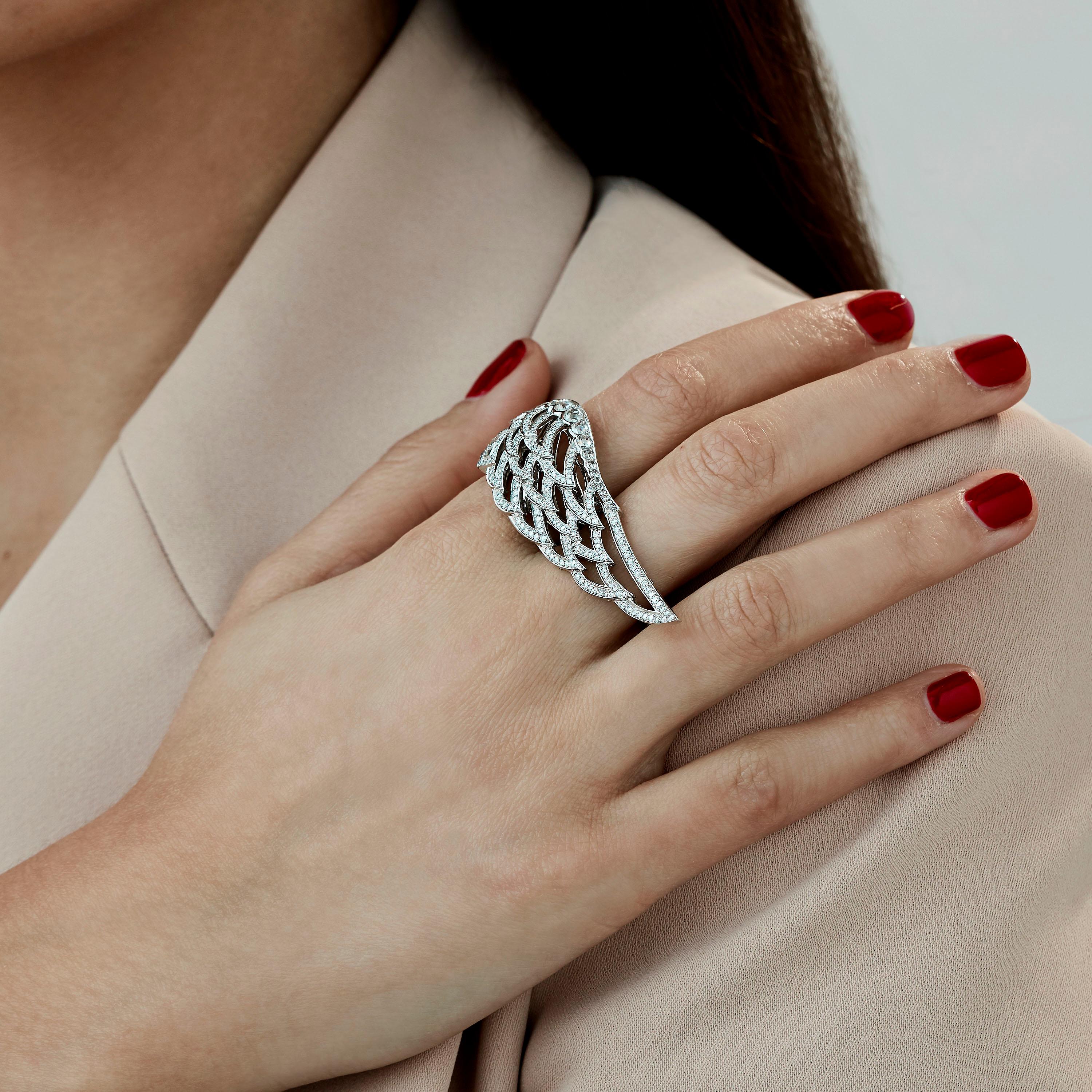 A House of Garrard of 18 karat white gold double finger ring from the 'Wings Lace' collection, set with round and rose cut white diamonds.

227 round white diamonds weighing: 1.05cts
18 rose cut white diamonds weighing: 0.53cts
Size 56/57

Please