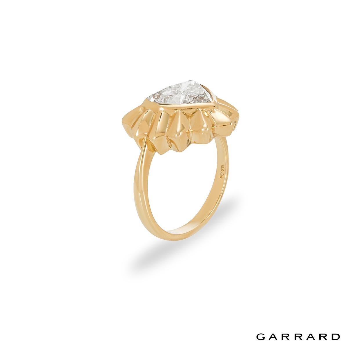 A unique 18k yellow gold Garrard diamond ring. The ring comprises of a heart motif with a heart cut diamond in a rubover setting. The diamond has a weight of 2.68ct, G colour and SI2 clarity. The ring is a size UK K½, US 5.75 EU 50.5 but can be