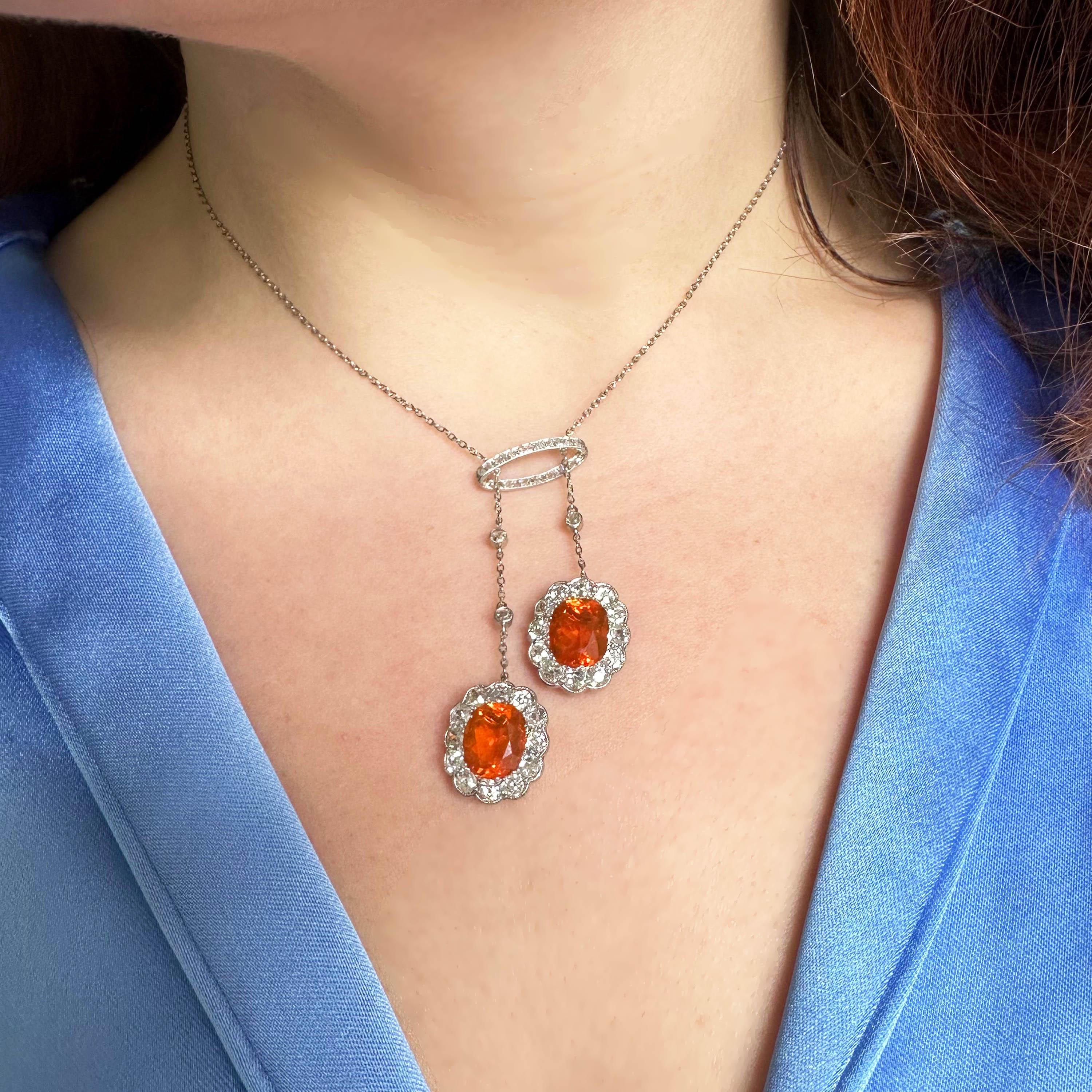 A Garrards fire opal and diamond drop earrings and negligee pendant set. The earrings have old European-cut diamond tops, in rub over settings, with four articulating, graduating rows of old European and rose-cut diamond set foliate motifs, in grain